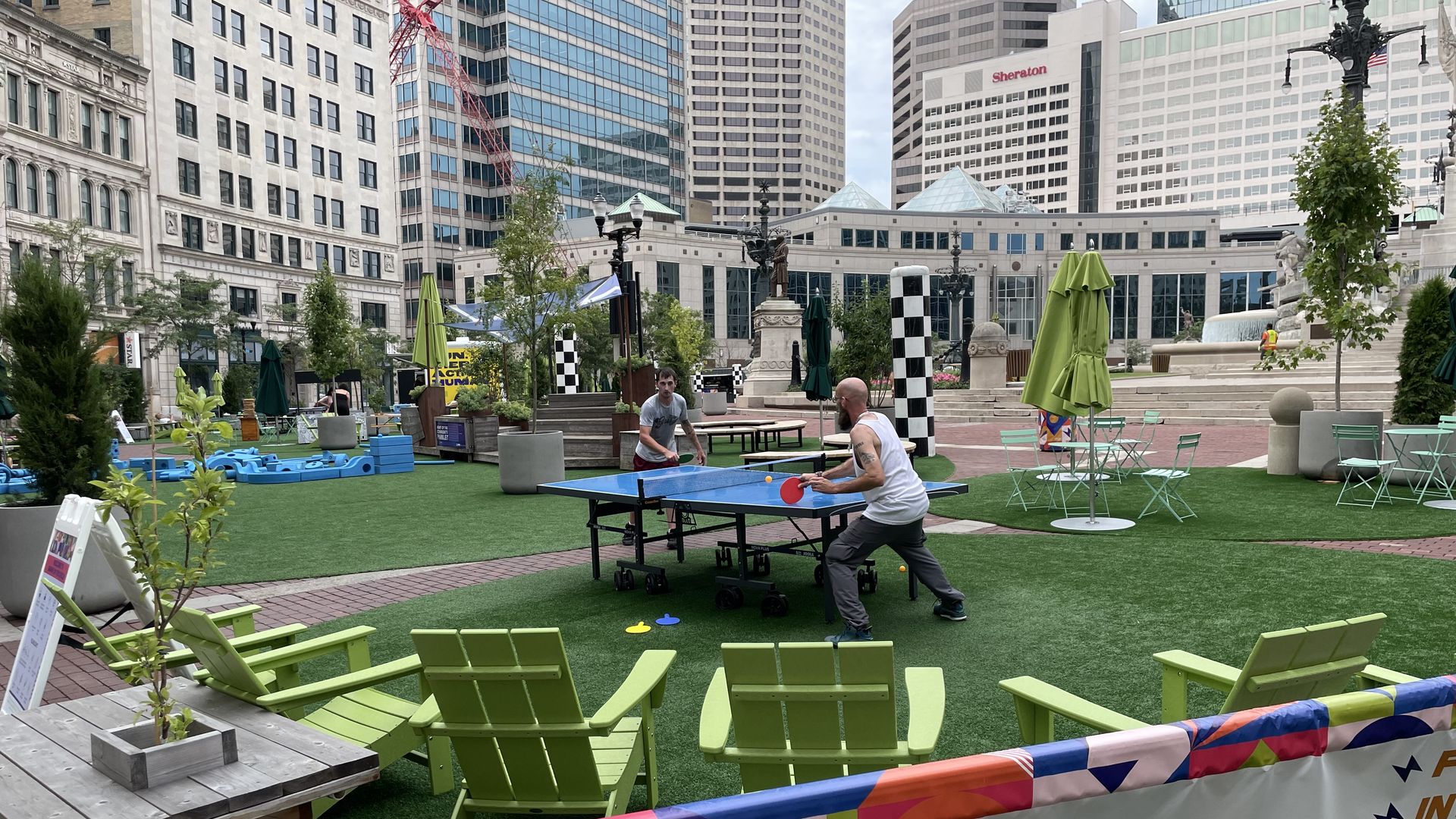 Two men play ping-pong in the mini-park on Monument Circle.