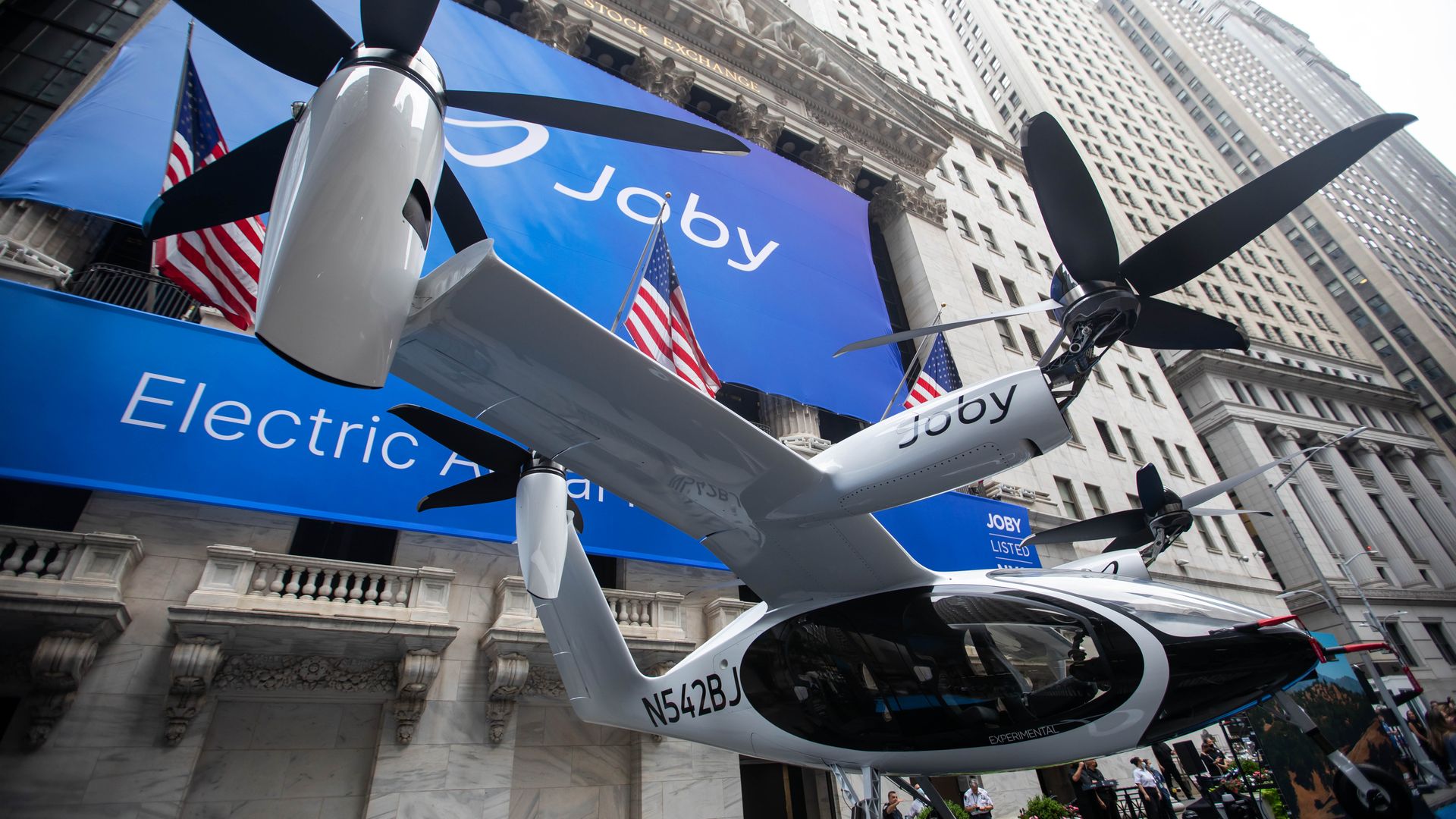 A multi-rotor Joby Aviation aircraft sits on display outside the New York Stock Exchange.