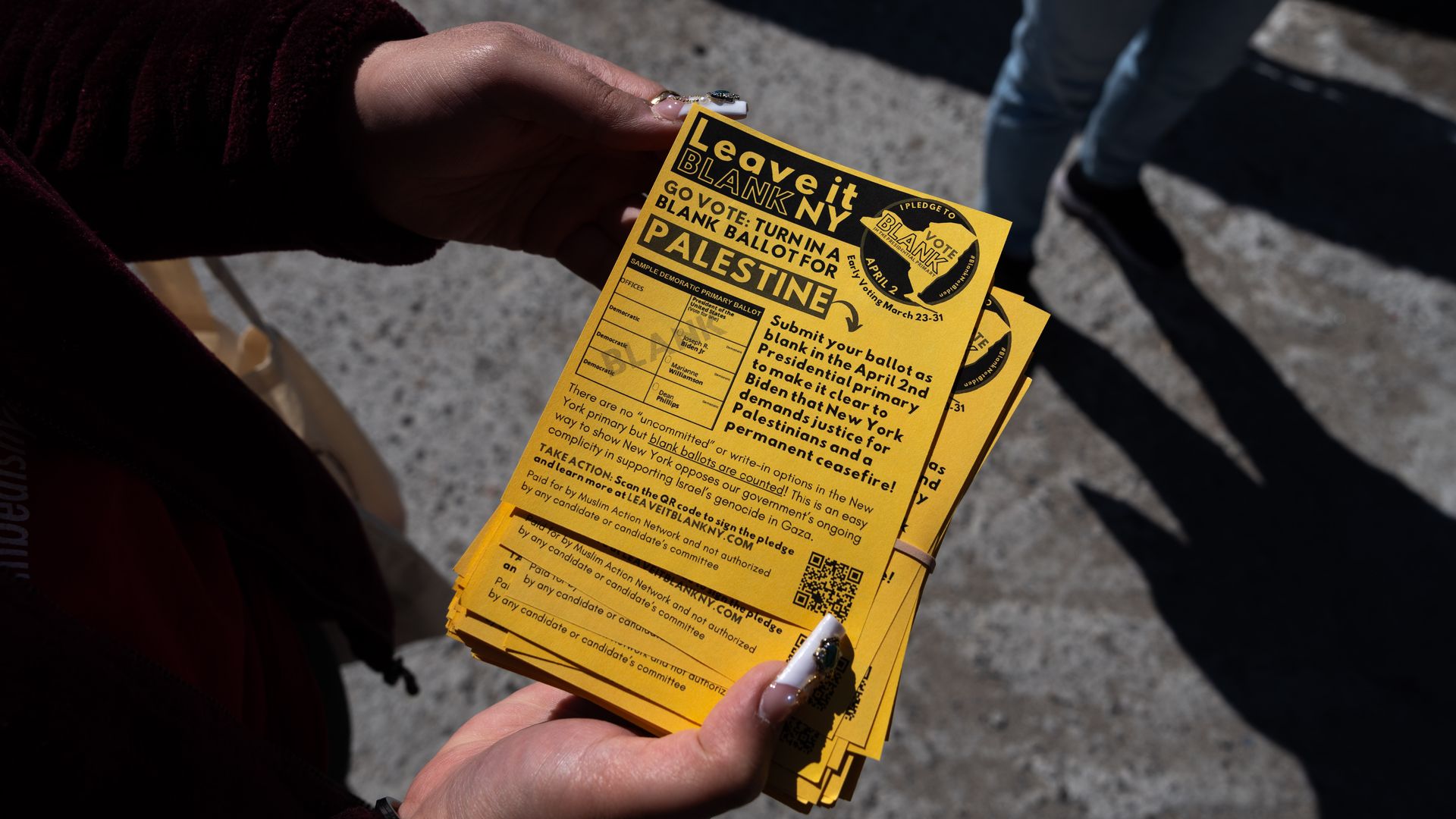 A person holding a "Leave it Blank" flyer