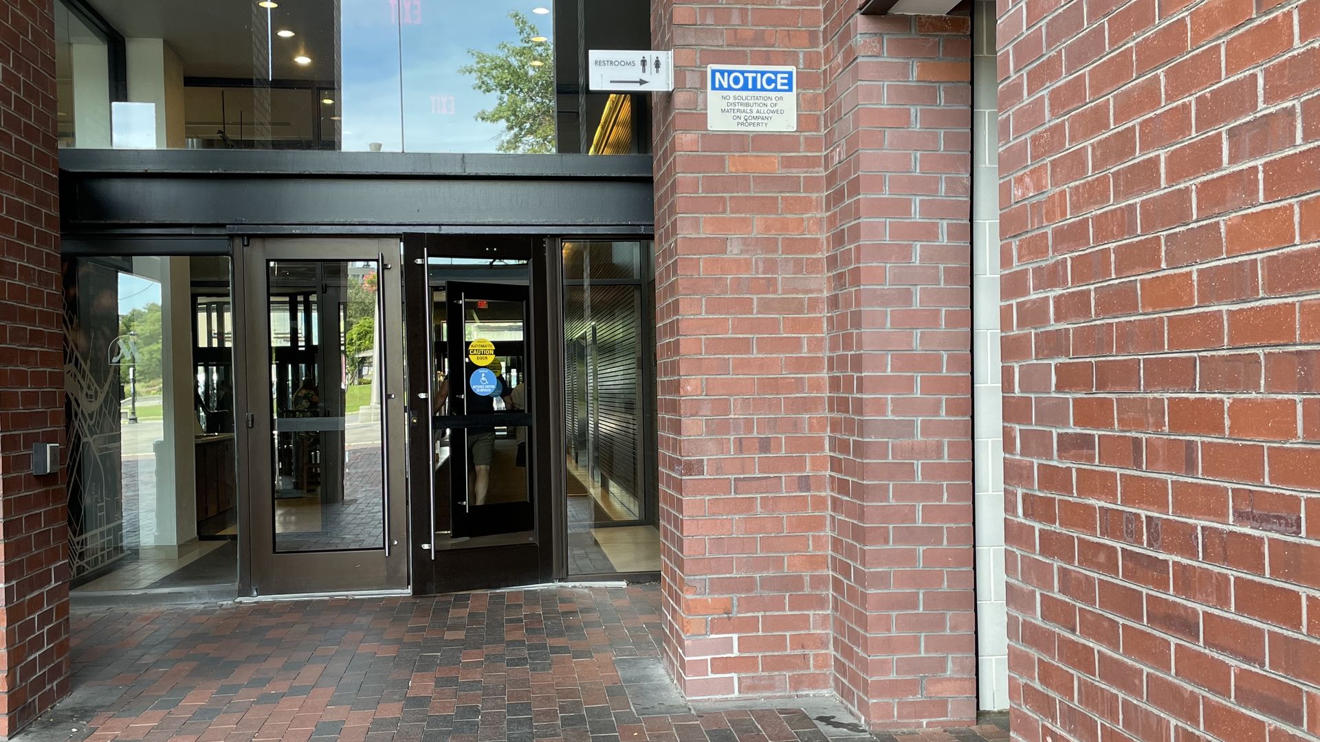 The bathrooms appear to the right of the Boston Long Wharf Marriott hotel entrance.