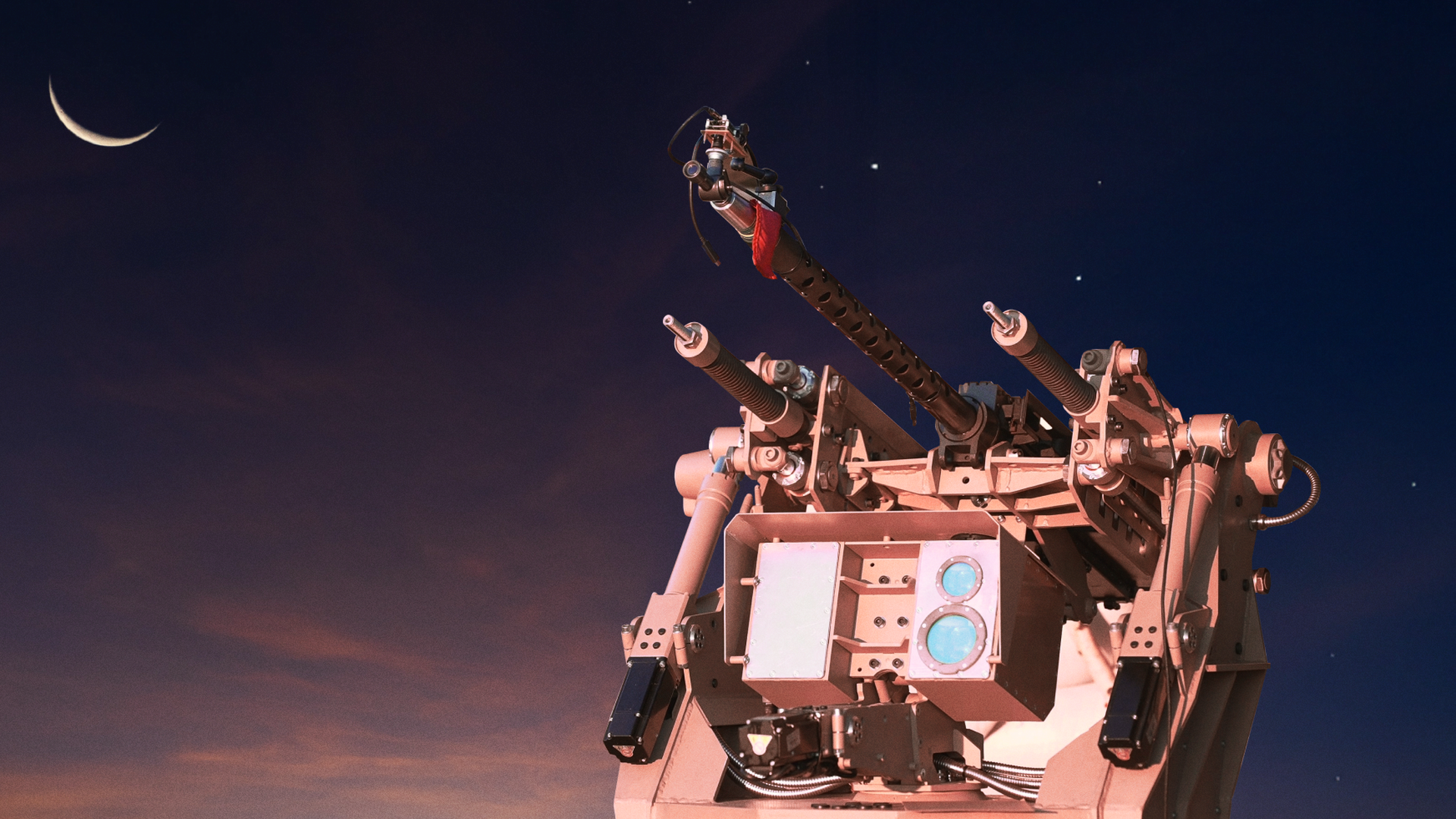 A futuristic turret, made for Ukraine's military, is photographed against a twilight sky. A crescent moon is seen in the top left corner.