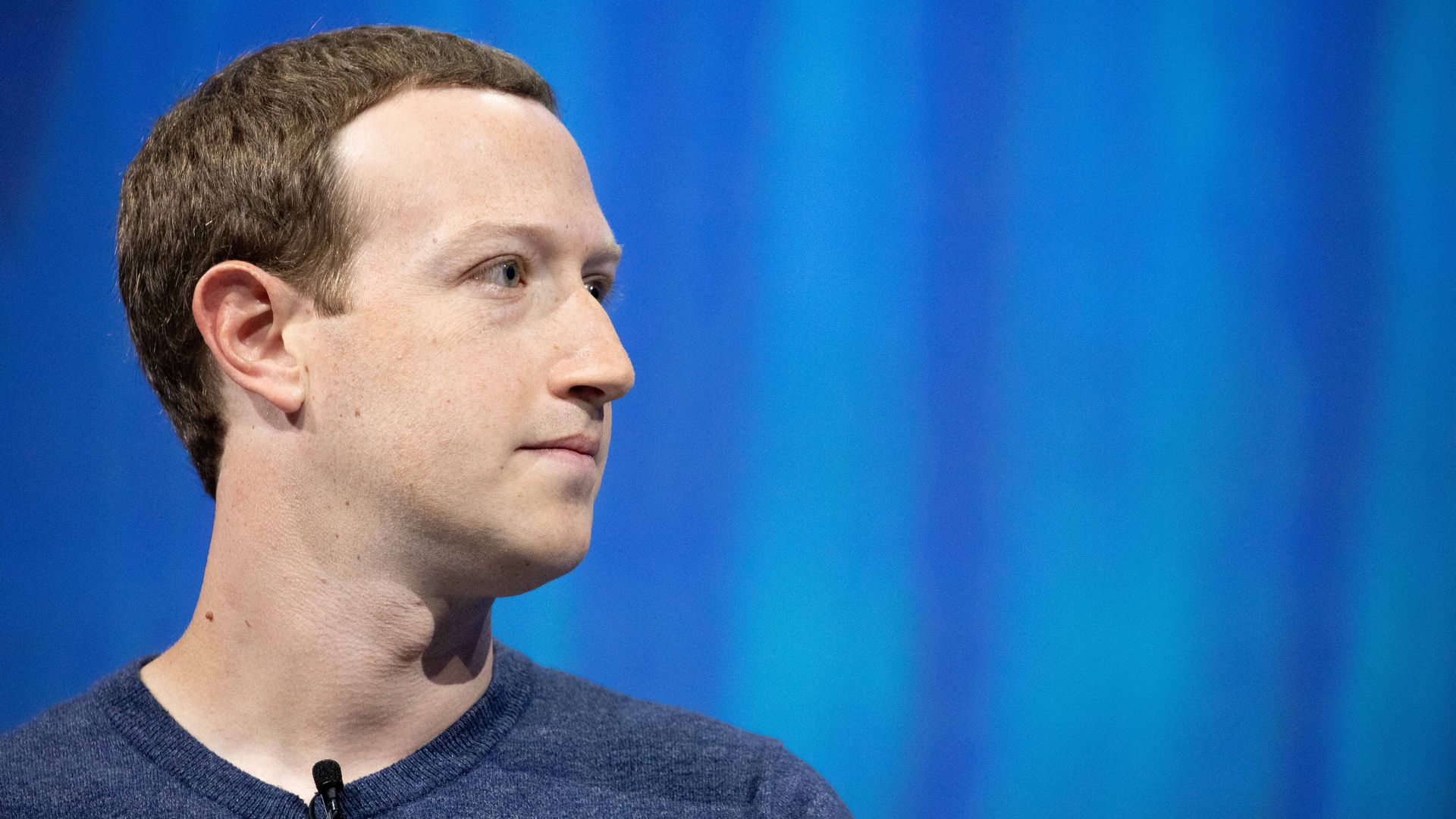 Mark Zuckerberg against a blue background
