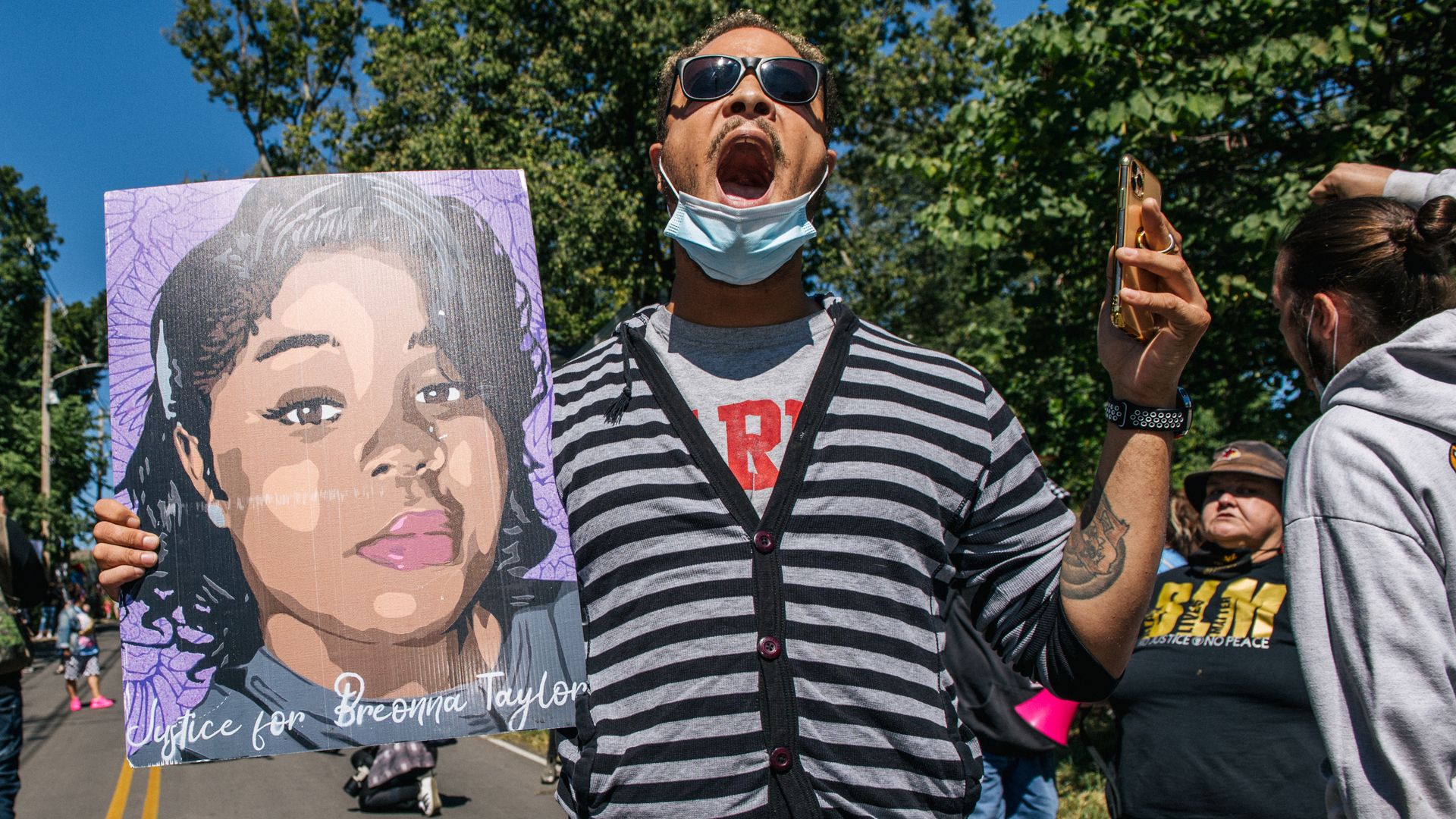 A demonstrator holds up a sign of Breonna Taylor while chanting during a protest (Photo by Brandon Bell/Getty Images)