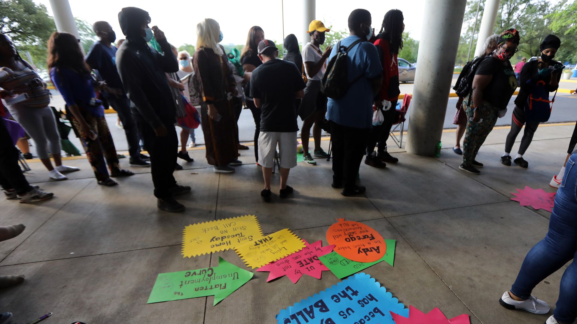 People wait in line to file for unemployment