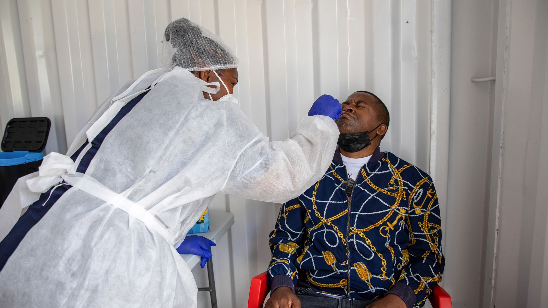 A health worker administers a nasal swab test at a Testaro Covid-19 mobile testing site