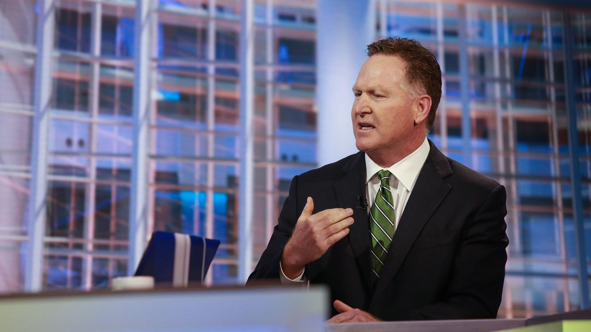 Mallinckrodt CEO Mark Trudeau speaks behind a newsdesk during an interview.