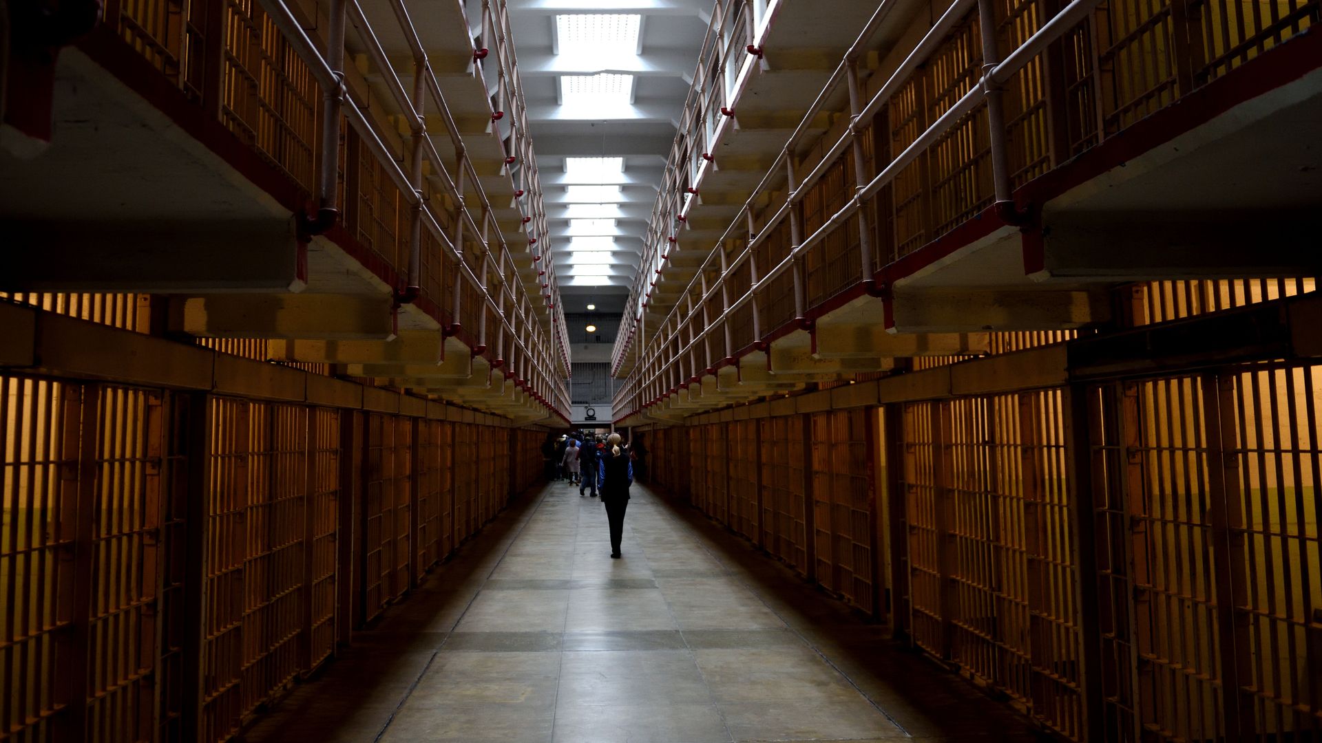 A hallway in between prison cells 