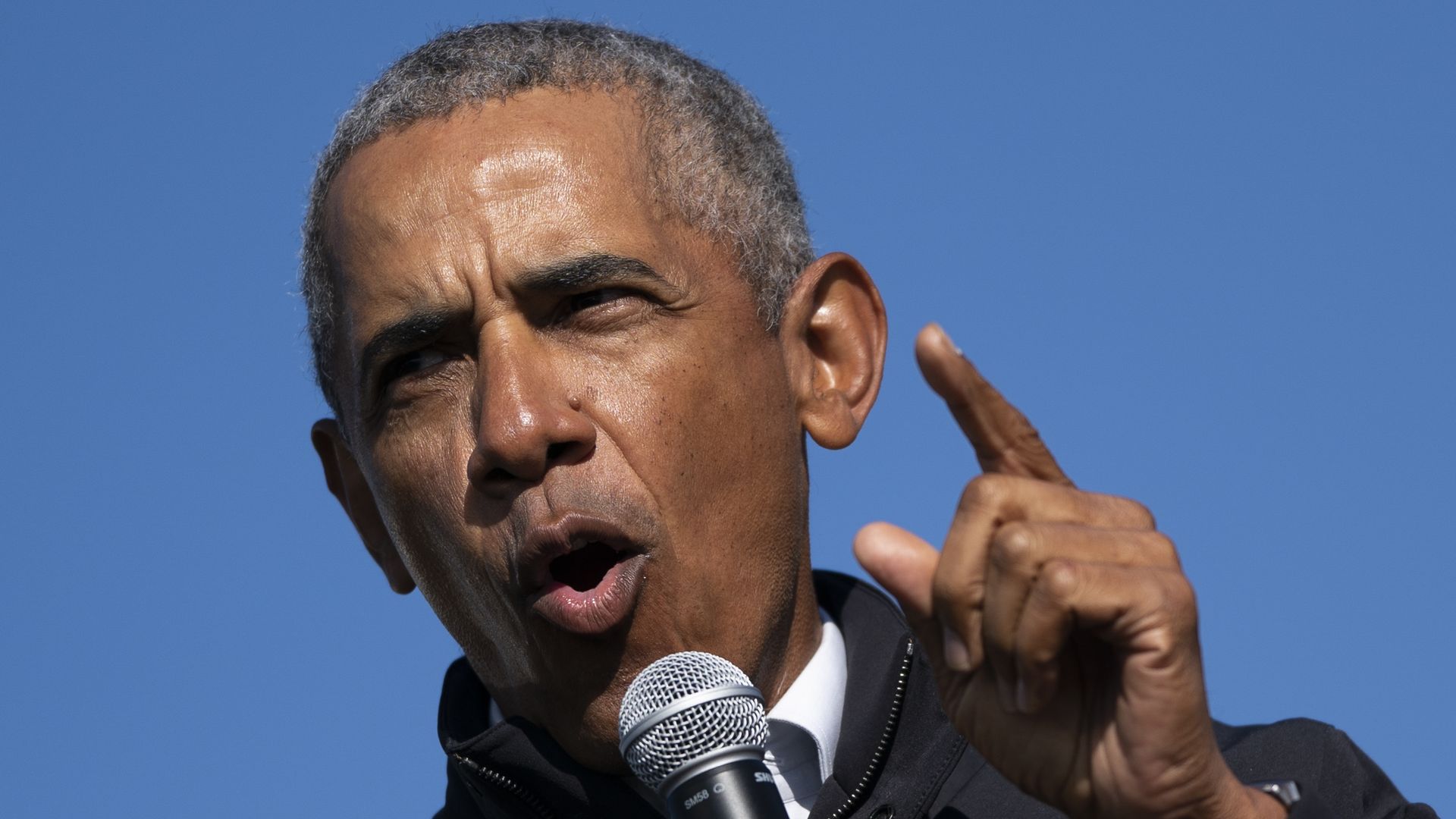 Former U.S. President Barack Obama speaks during a drive-in campaign rally for Democratic presidential nominee Joe Biden at Northwestern High School on October 31, 2020 in Flint, Michigan.