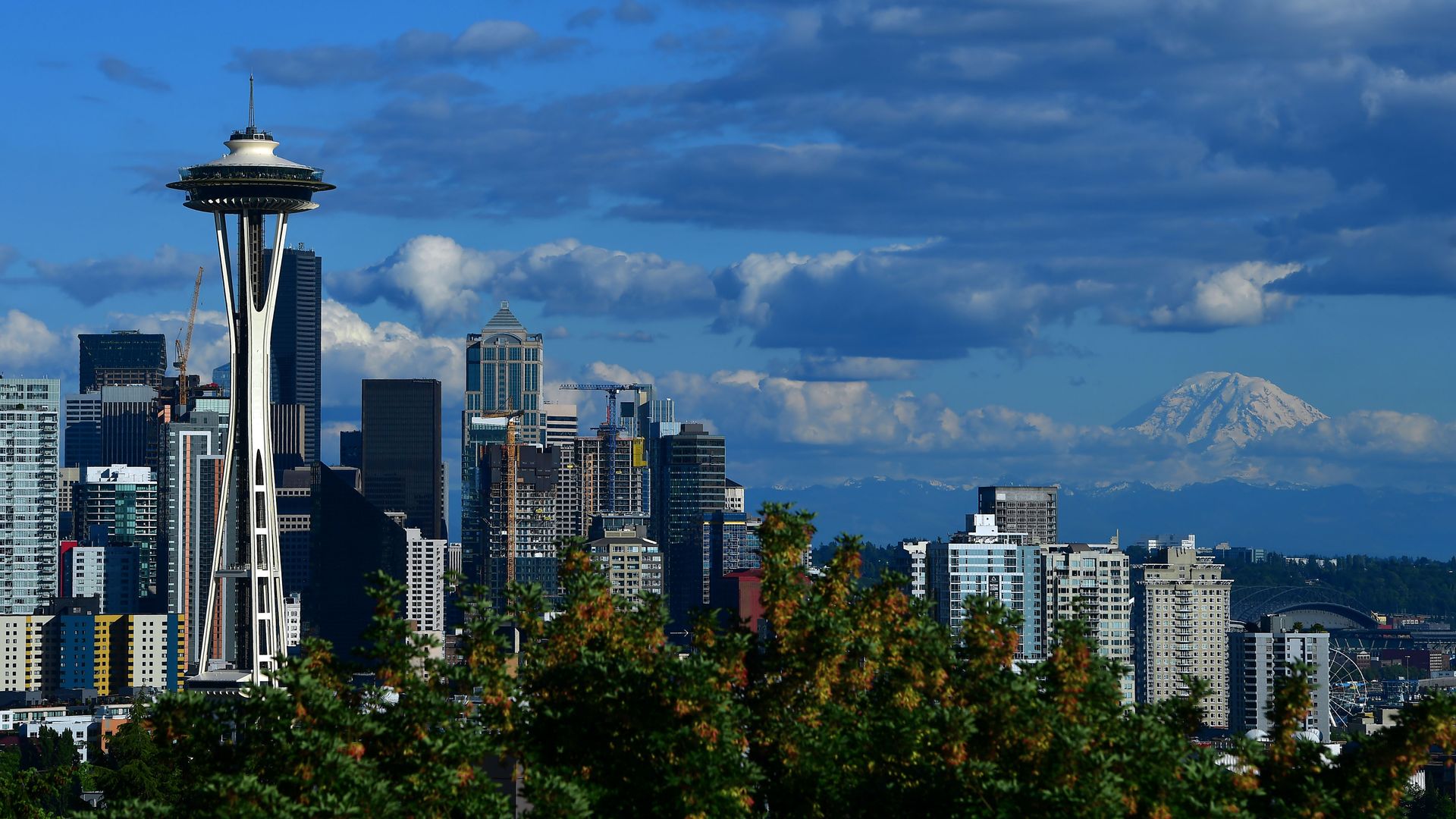 Seattle skyline with blue sky and some clouds.