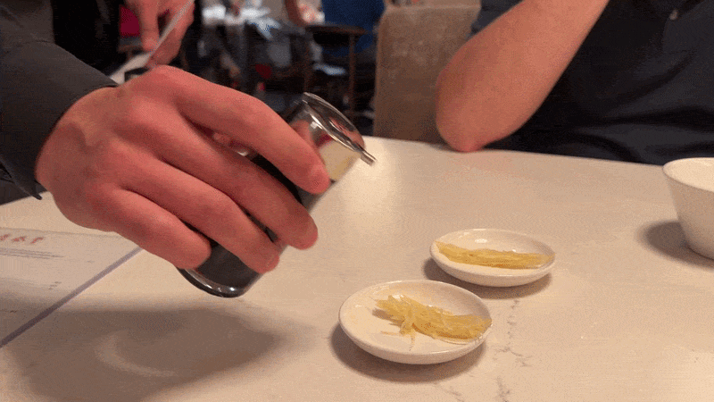A gif of someone pouring soy sauce into a dish.