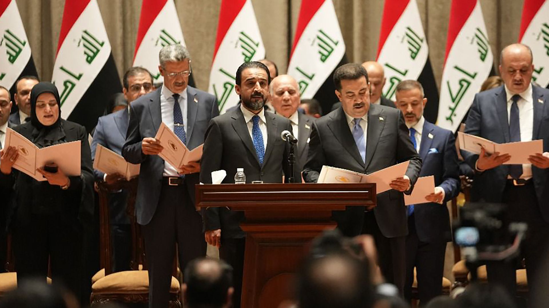 Prime Minister-designate Mohammed Shia' al-Sudani (R, front) and his cabinet members are sworn in at the Iraqi parliament in Baghdad, Iraq, on Oct. 27, 2022. 