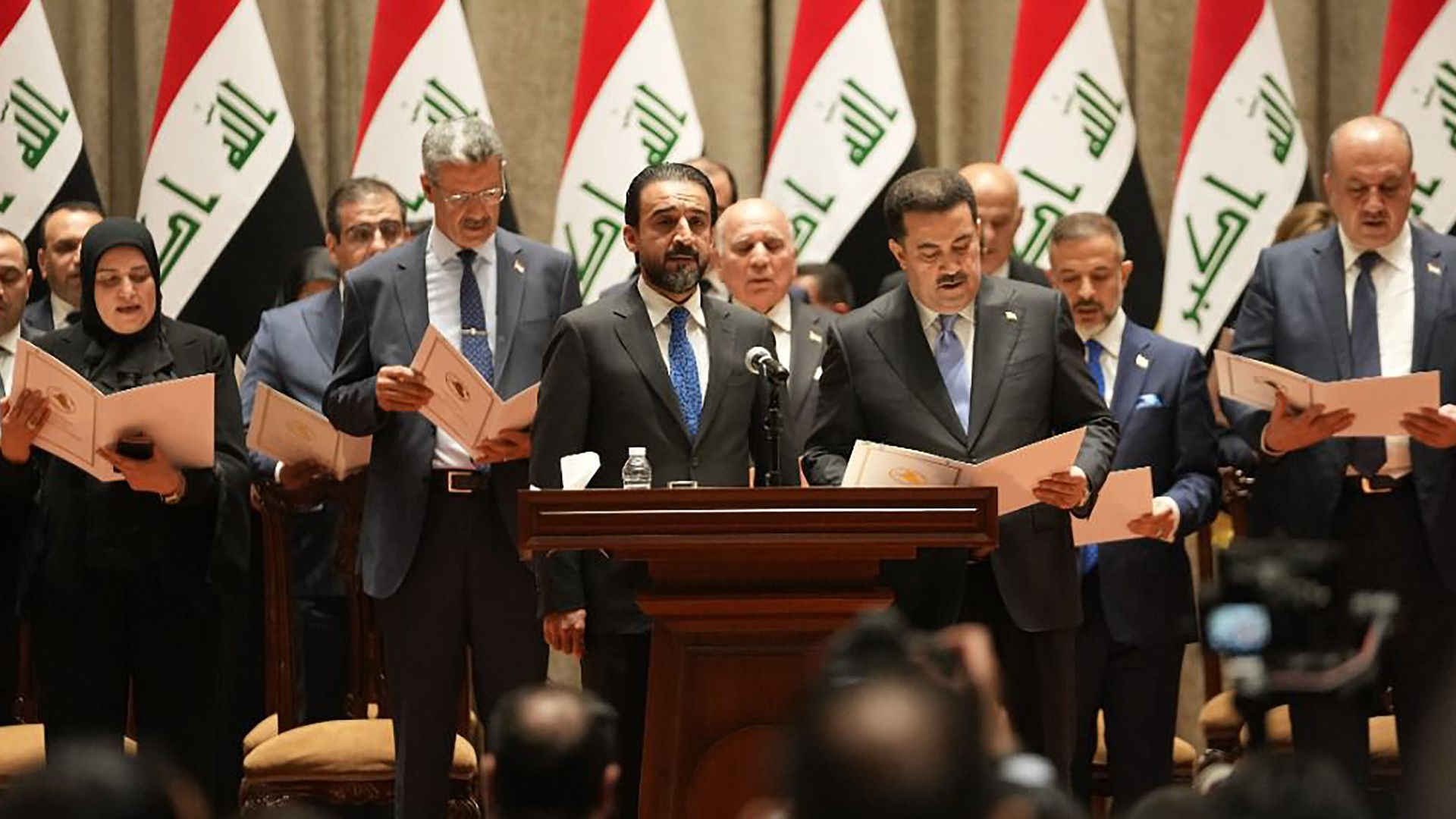 Prime Minister-designate Mohammed Shia' al-Sudani (R, front) and his cabinet members are sworn in at the Iraqi parliament in Baghdad, Iraq, on Oct. 27, 2022.