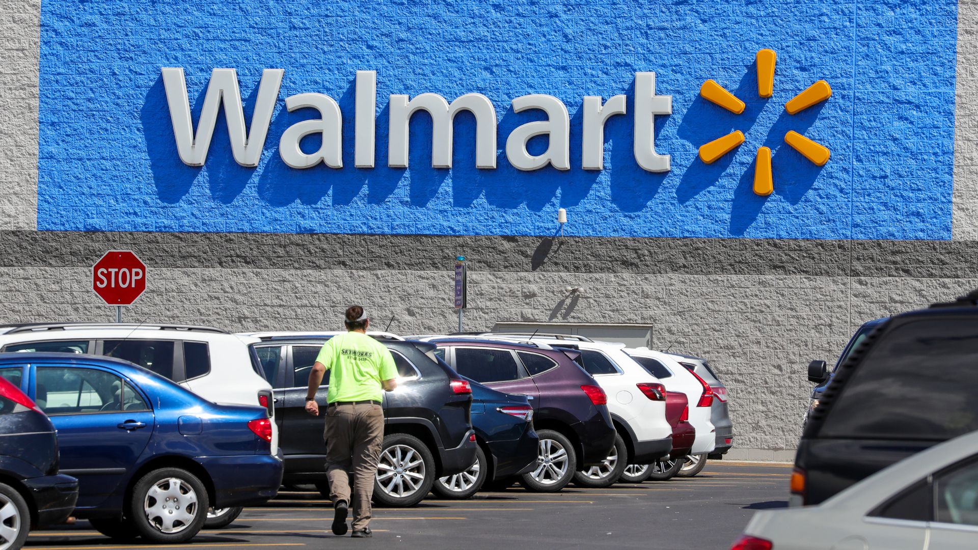 Shopper walking in parking lot of a Walmart store
