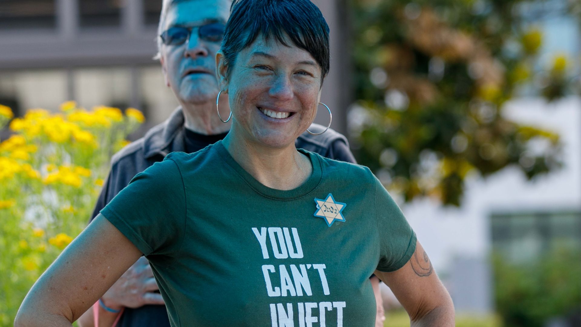 A woman wearing a yellow Star of David attends an anti-vaxxer protest near the Oregon State Capitol in Salem, Oregon.