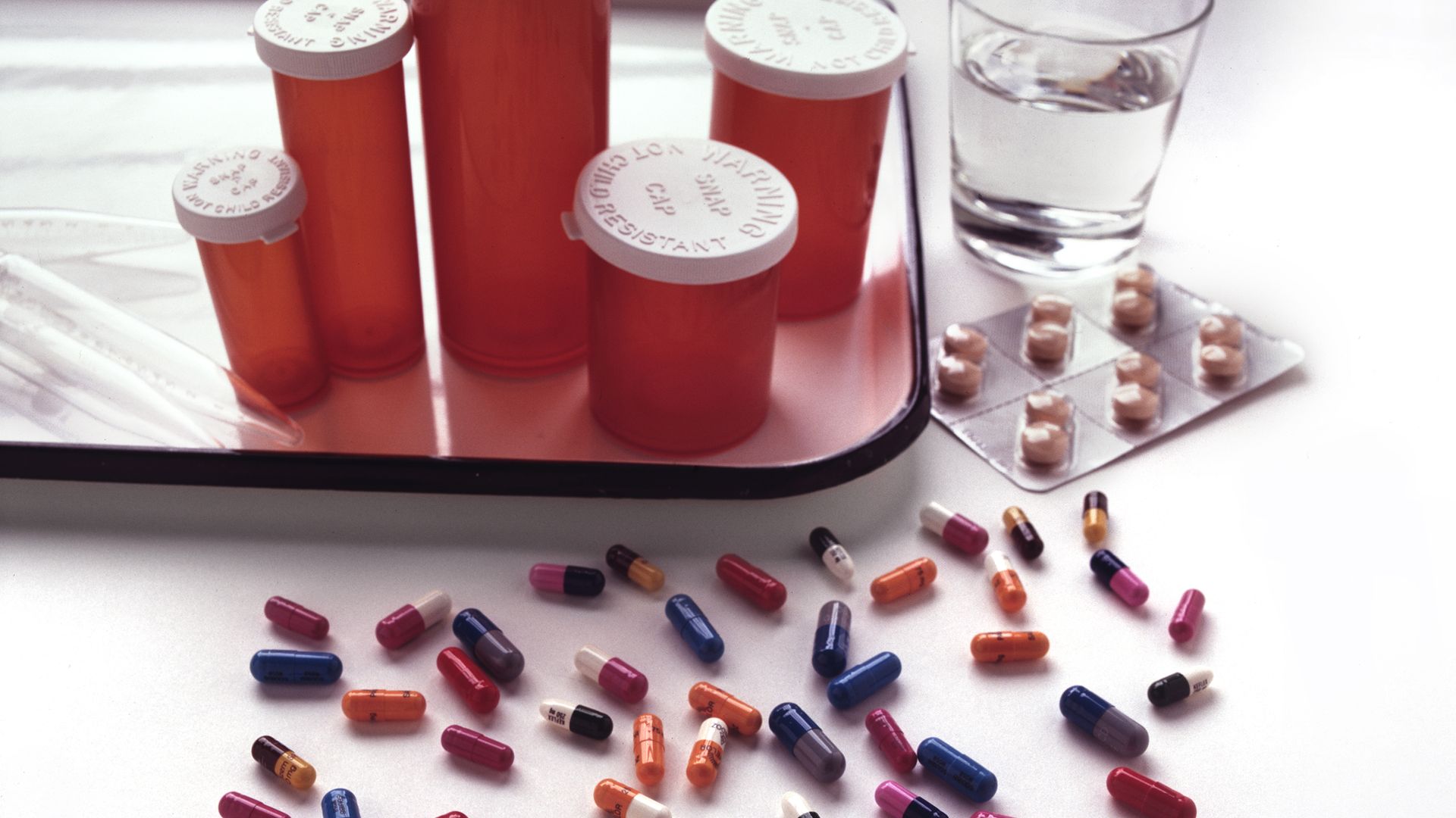 Pill bottles and prescription drugs on a table.