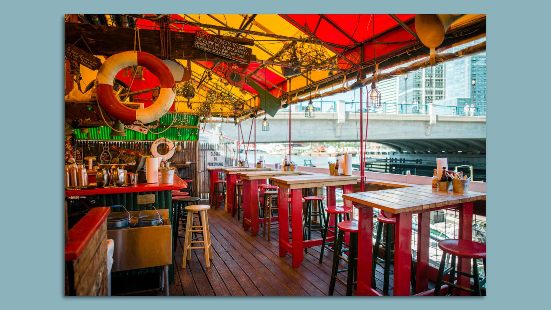 The interior of The Barking Crab in the Seaport, which has some high top tables overlooking the Boston waterfront.