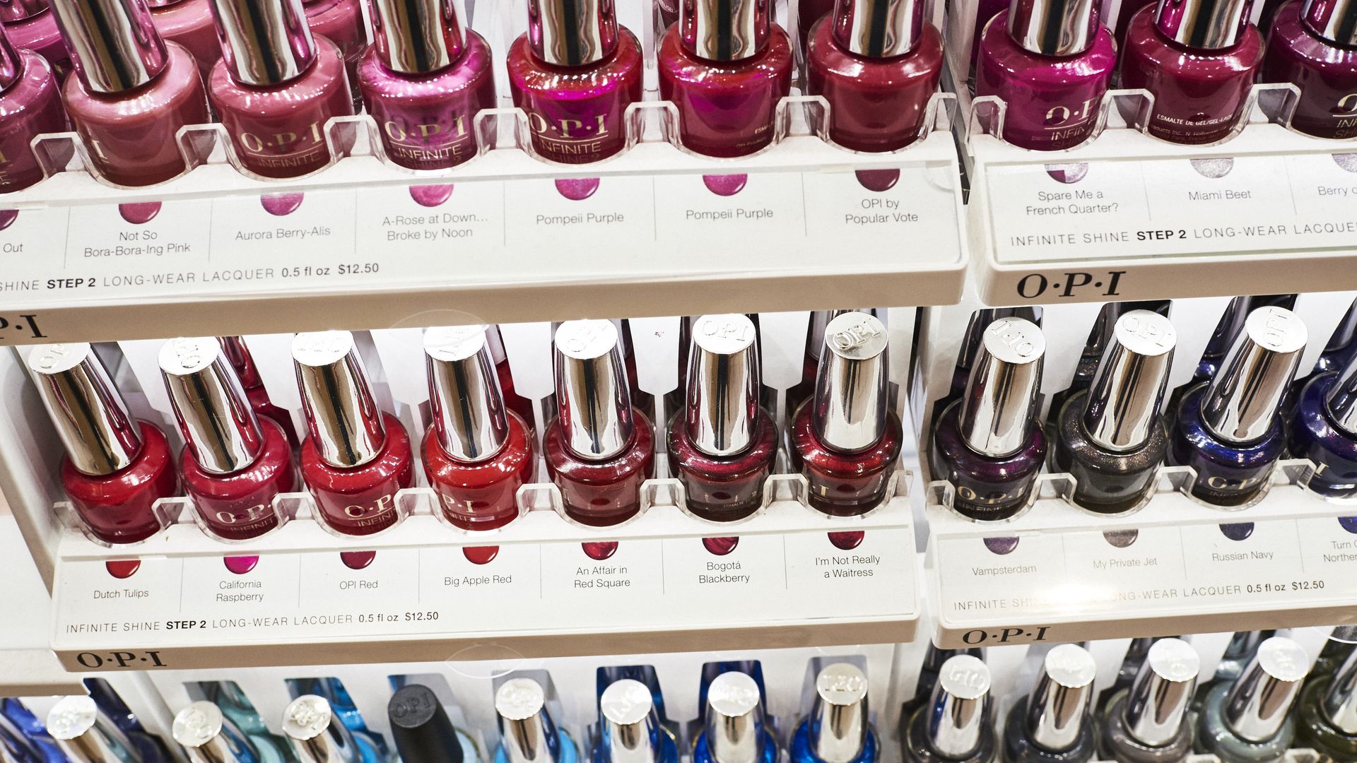 A close-up picture of rows of OPI nail polish colors.