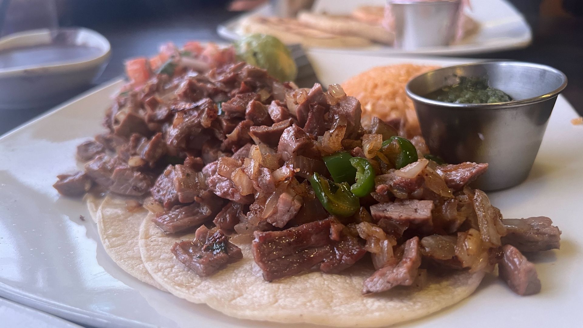 A closeup photo of tacos topped with chopped beef 