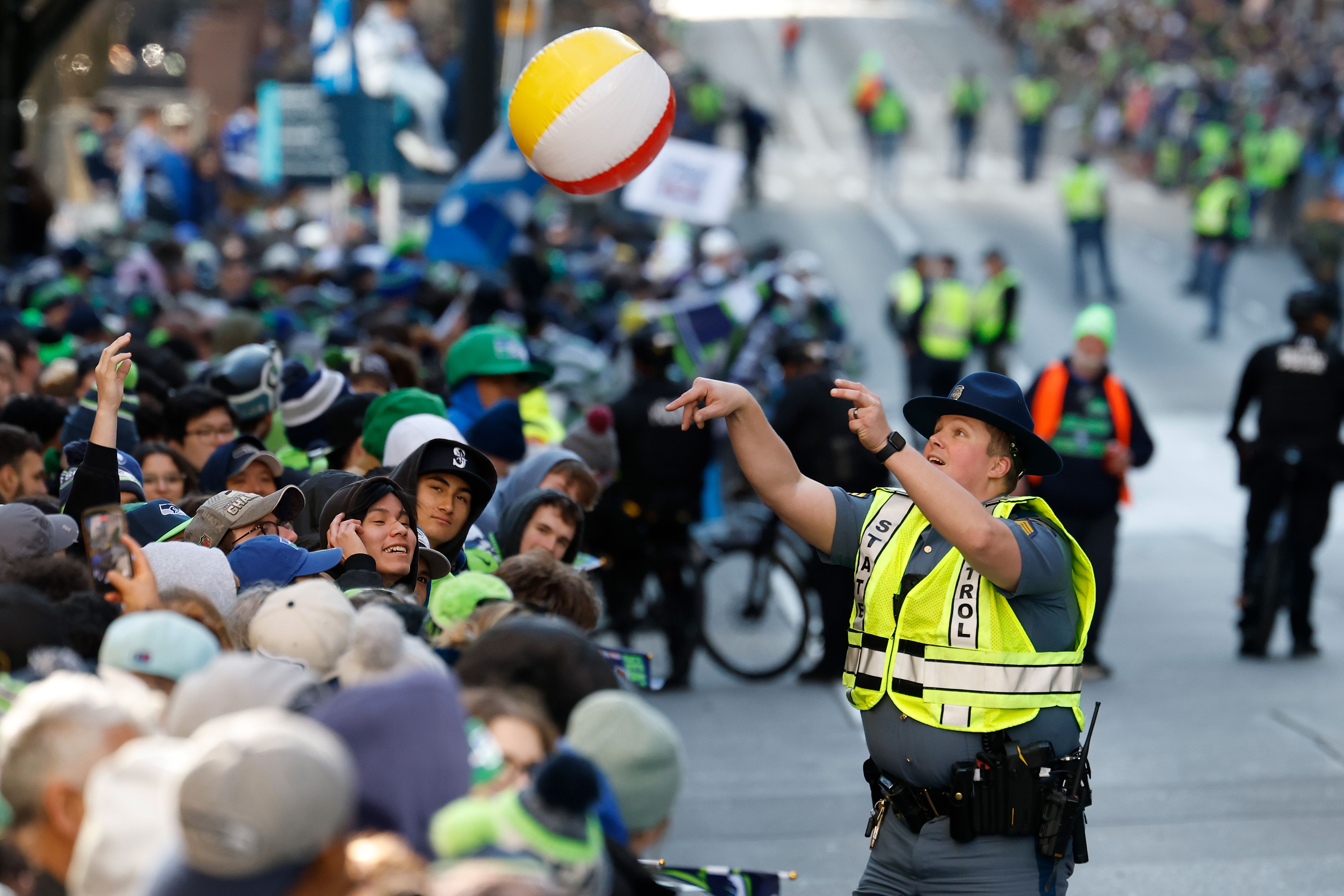 A state trooper interacts playfully with the crowd at the Seahawks victory parade.