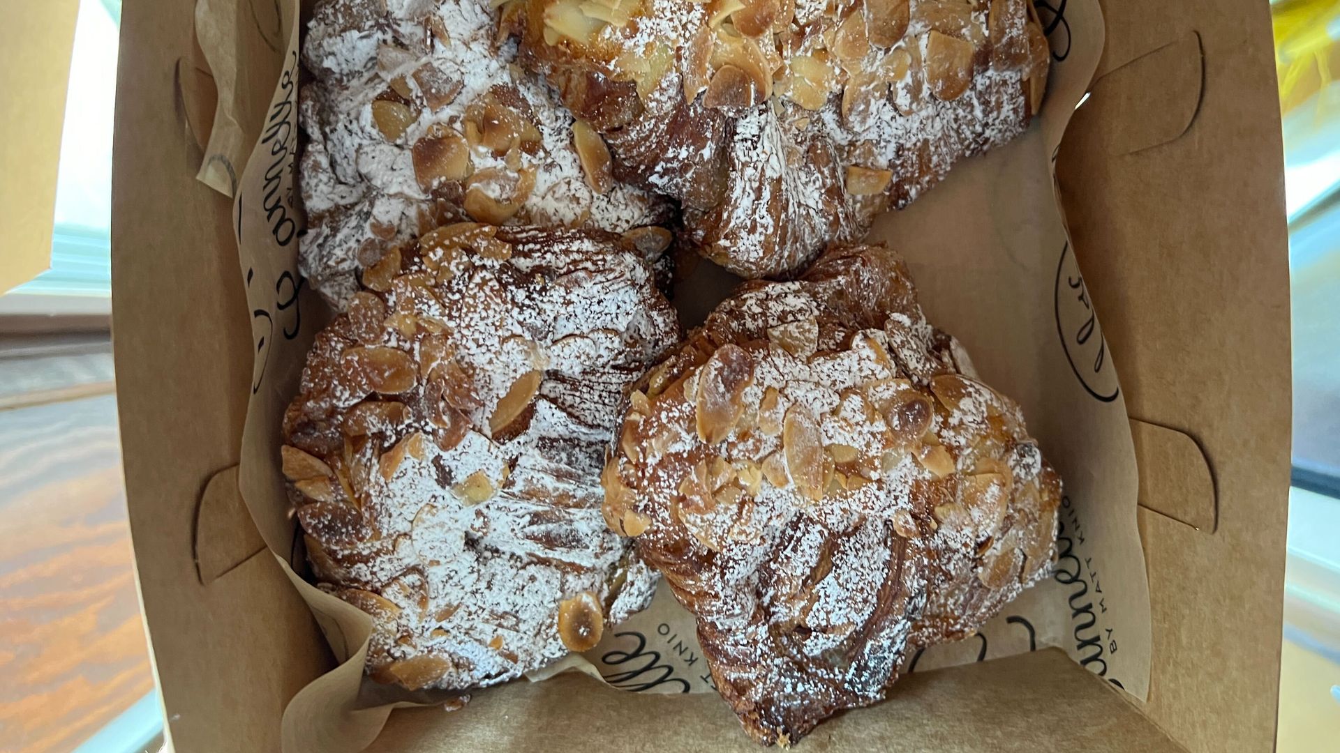 A cardboard box full of croissants from Canelle in Detroit
