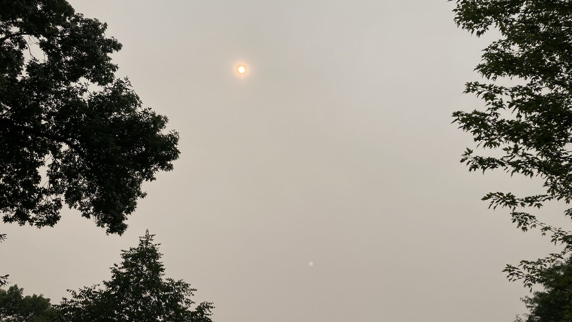 A dim sun blocked by hazy air  