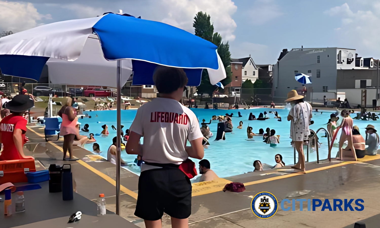 The Bloomfield Pool with a lifeguard in the foreground