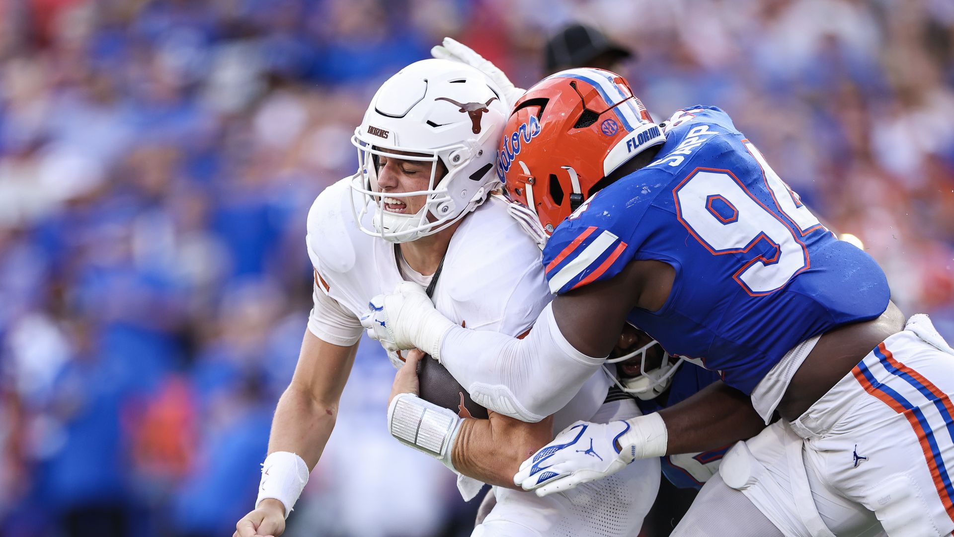 Texas quarterback Arch Manning getting sacked by a Florida player.