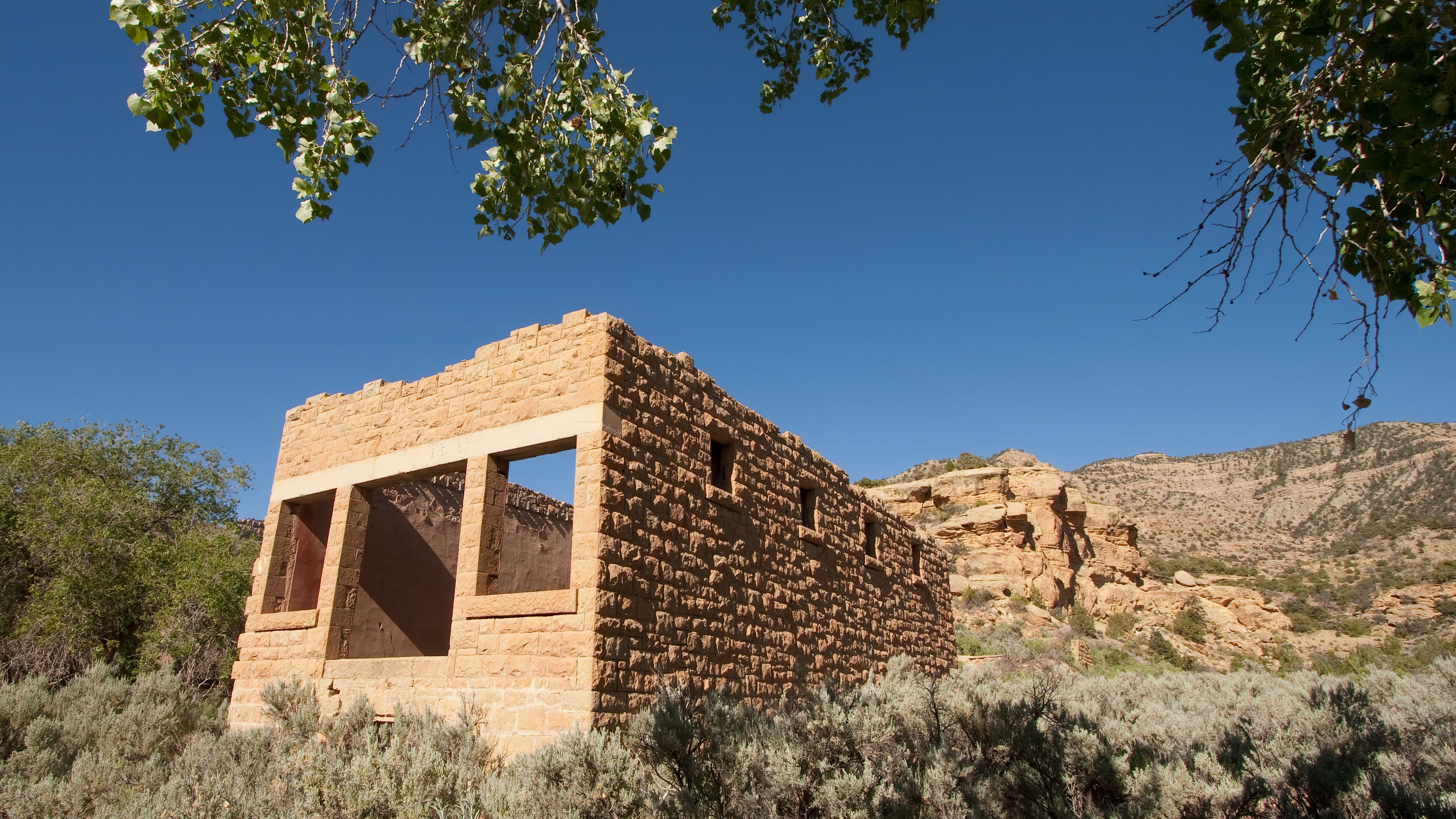 Ruins of a large building made of orange stone