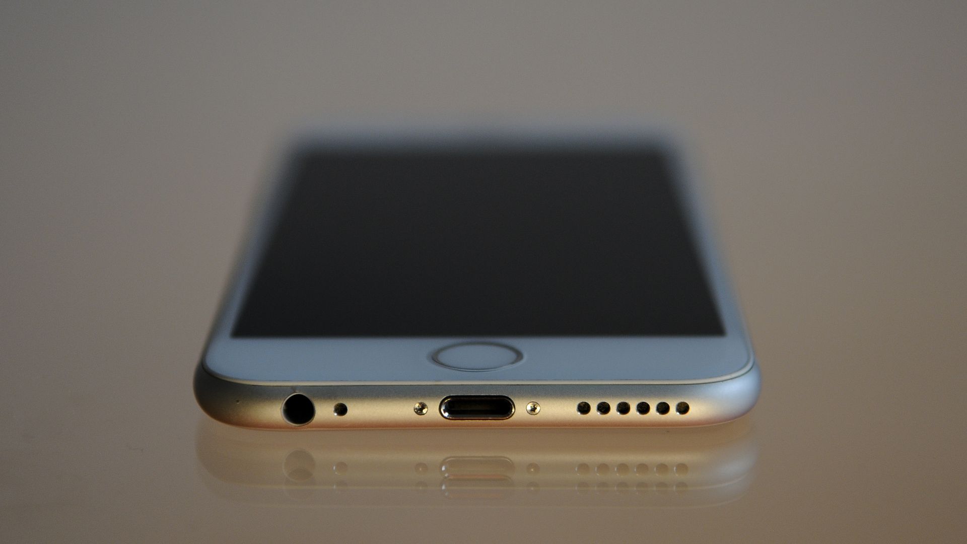 An iPhone 6 viewed with the charging port in foreground