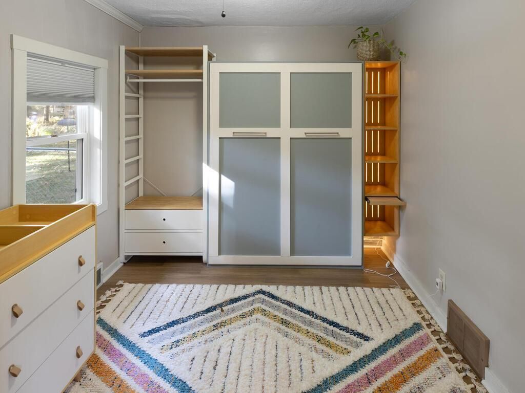 A bedroom with shelving. 