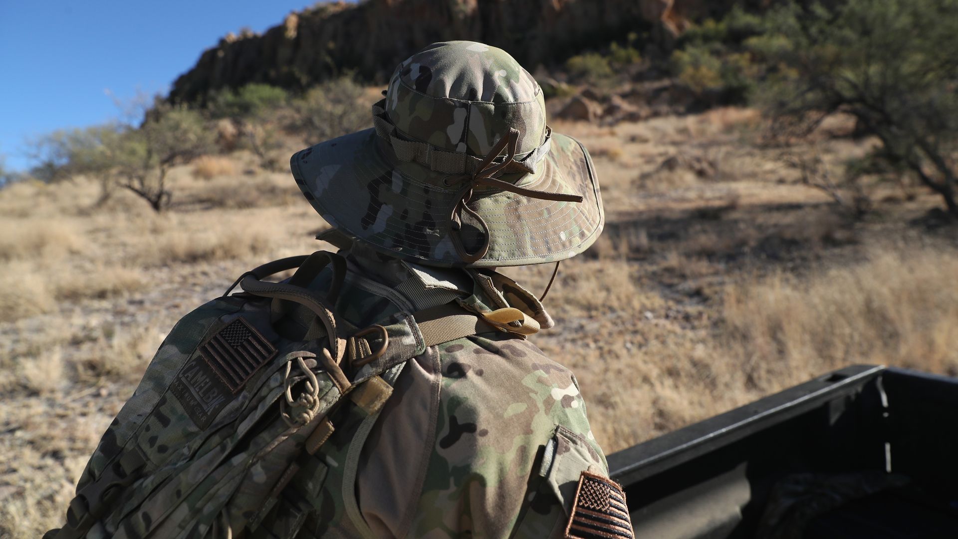 A civilian paramilitary with Arizona Border Recon watches for drug smugglers and undocumented immigrants crossing the U.S.-Mexico border near Arivaca, Arizona. Photo: John Moore/Getty Images