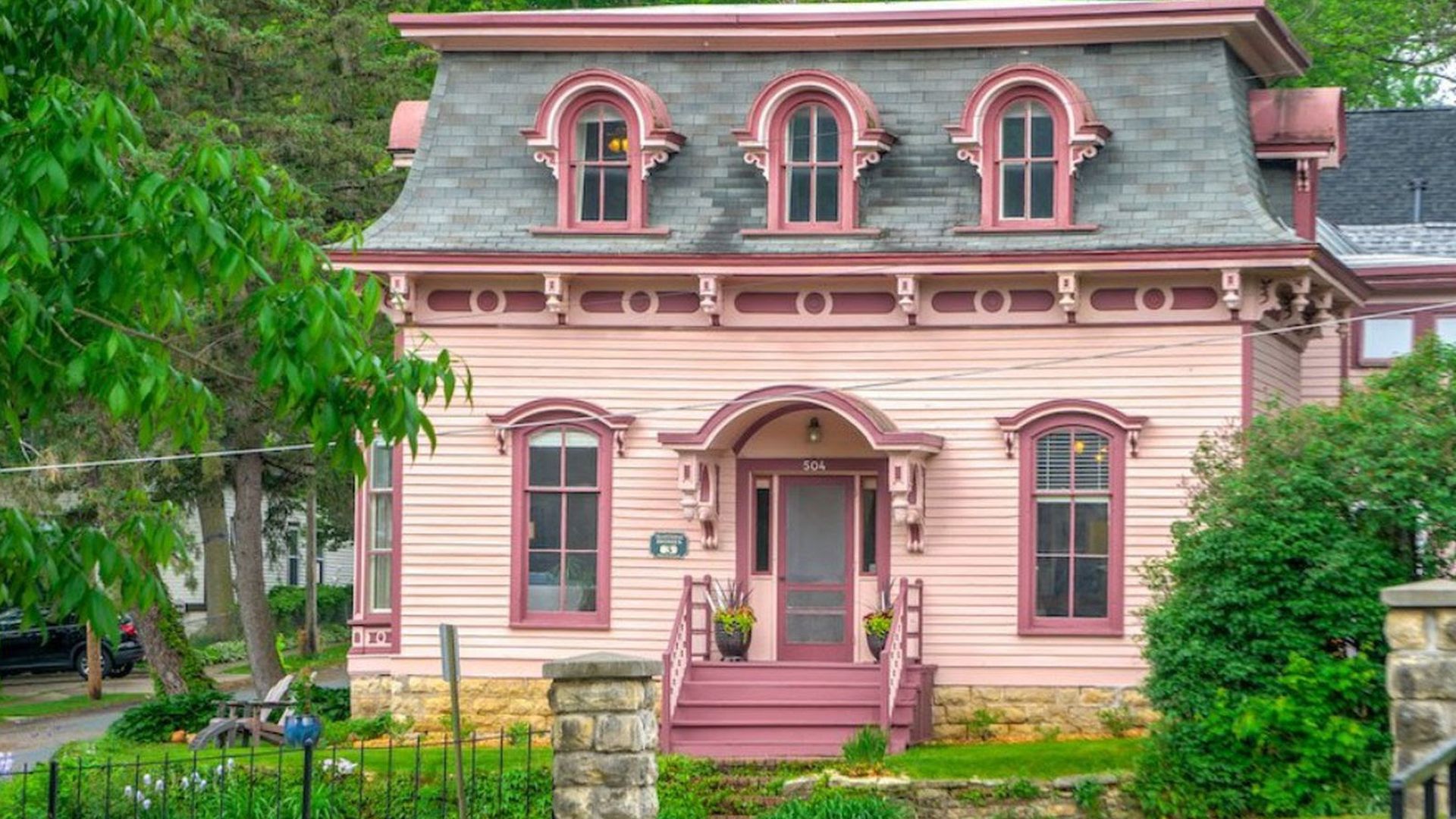 The exterior of the pink historic Ivory McKusick House in Stillwater, Minnesota.