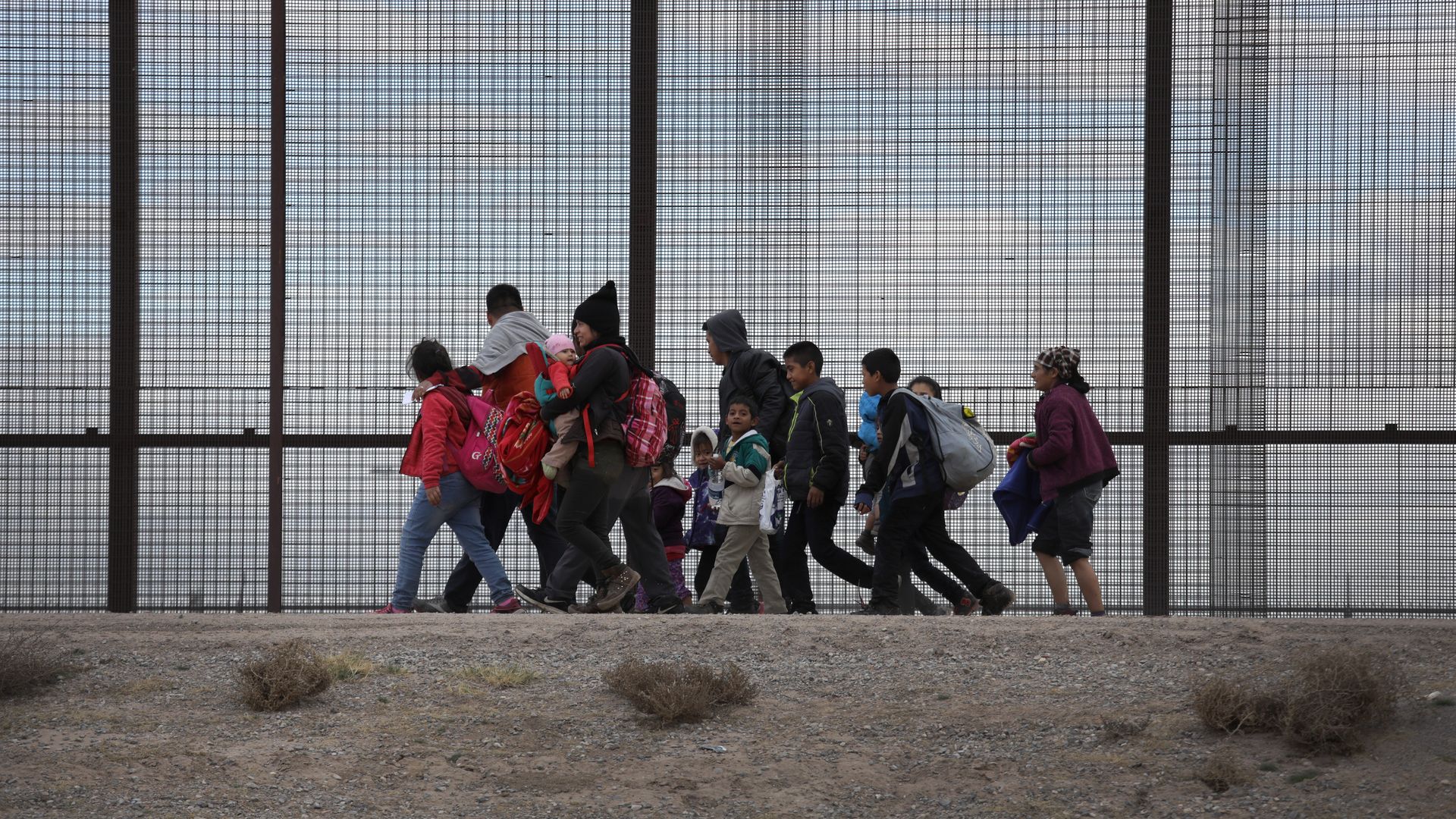 Migrants at the border fence. 