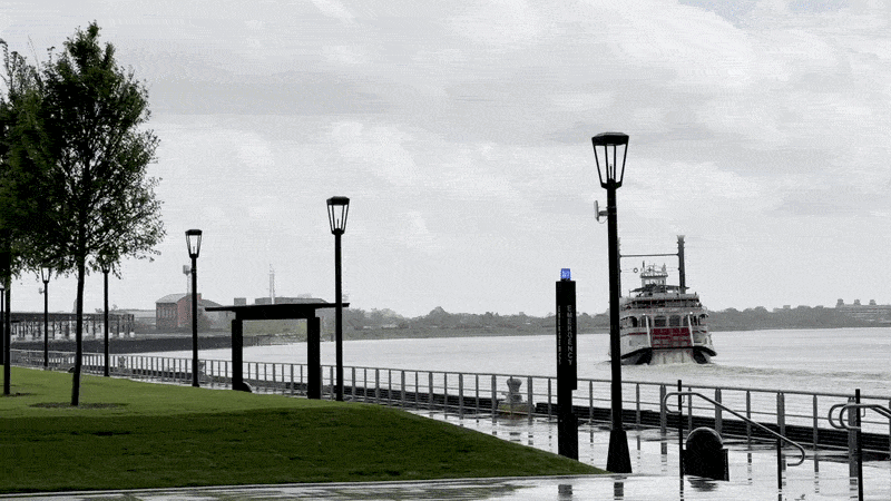 Image shows a Mississippi River boat and a green lawn.