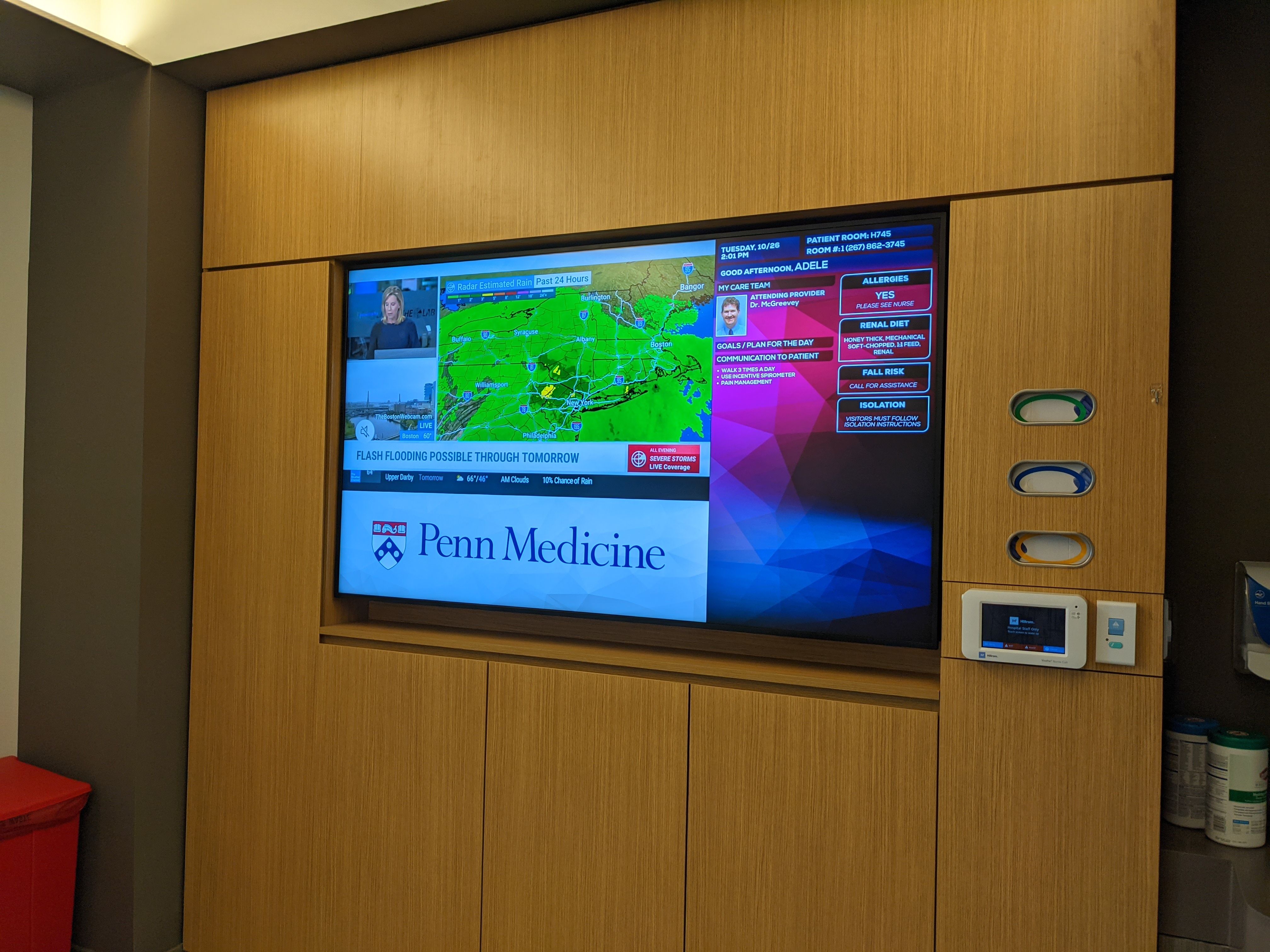 A 75-inch television hangs on a wall in a patient room inside the Pavilion, which serves  as the hub for the IRIS system. 
