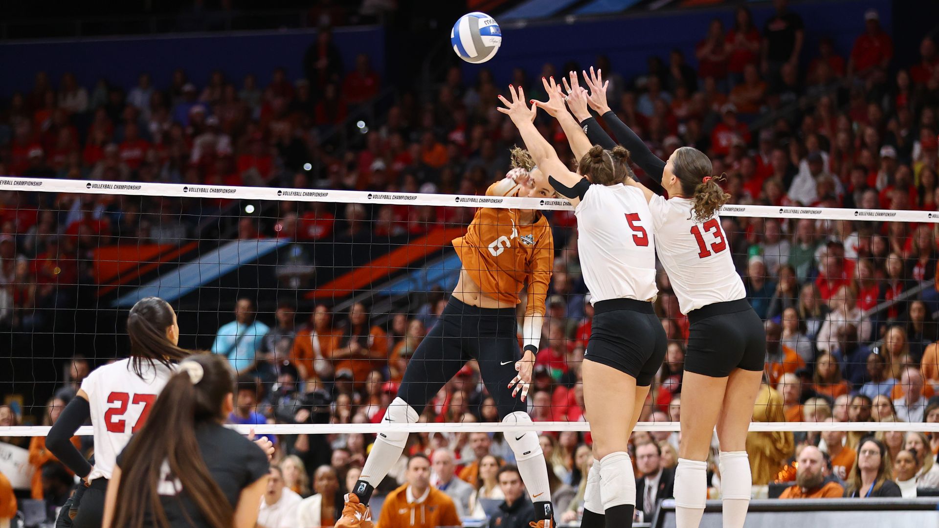 A University of Texas spikes the ball.