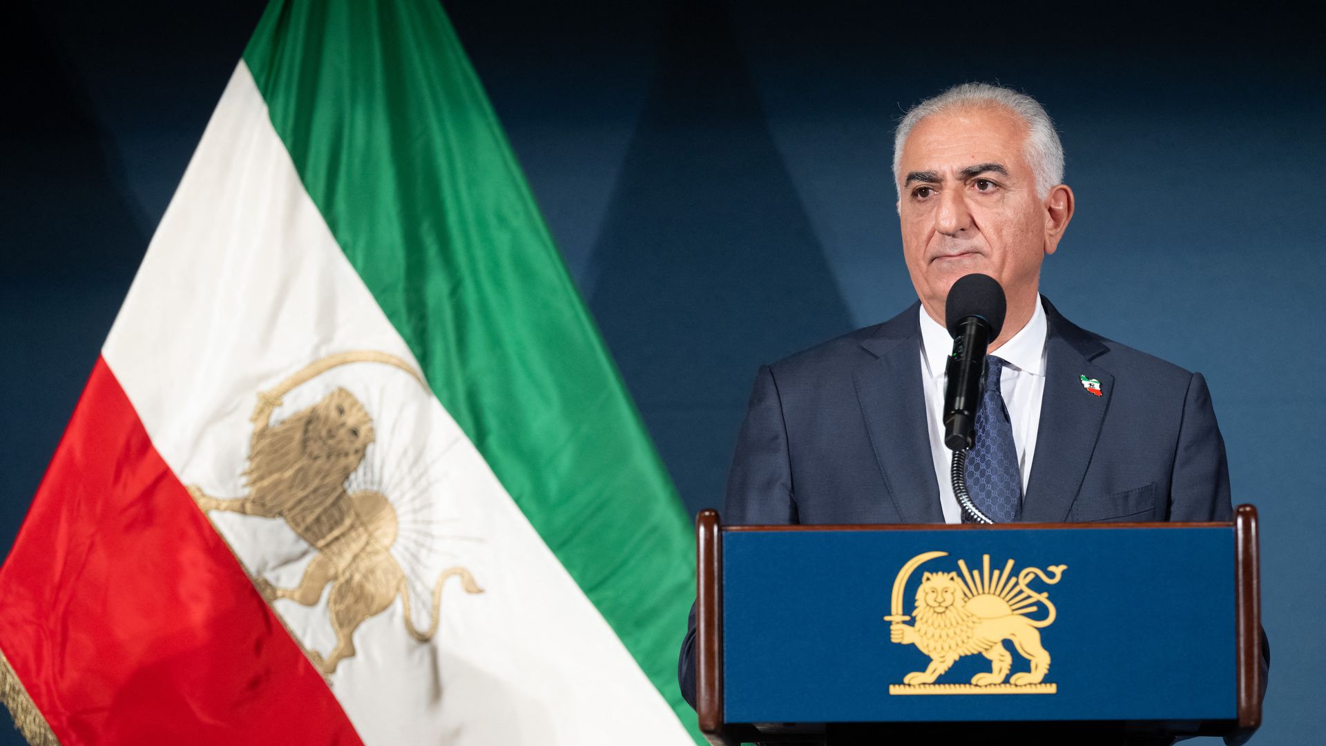 Man at podium with flag