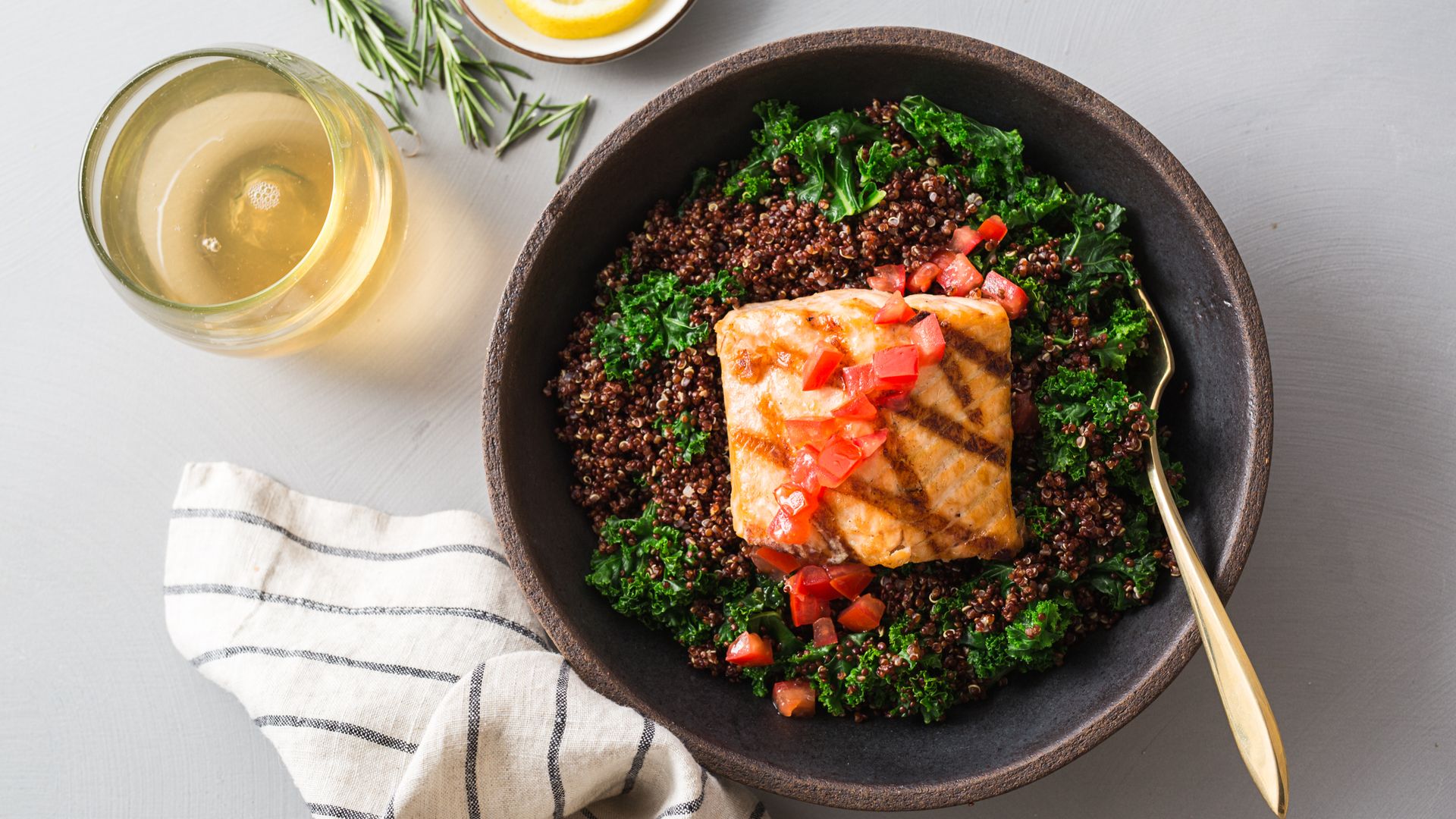 Plate of food with salmon on a bed of greens
