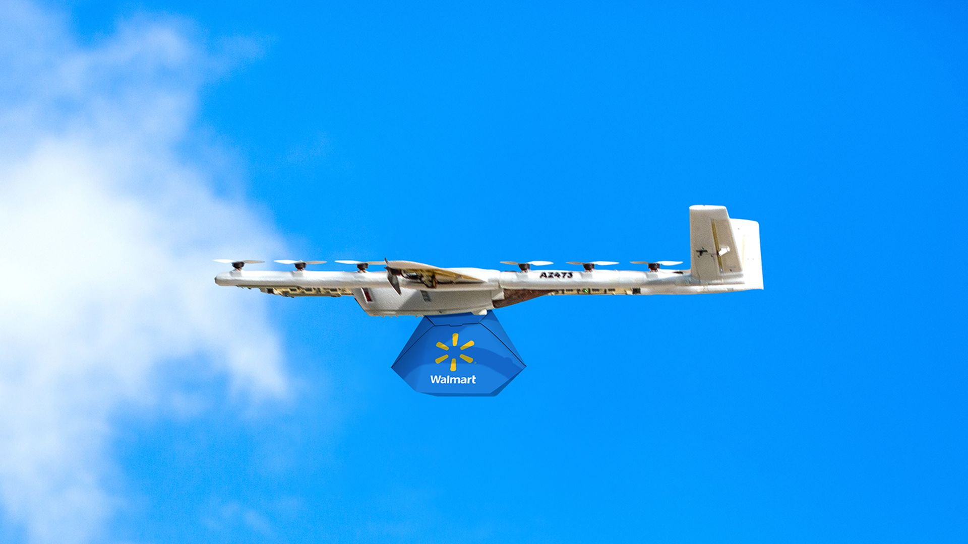 A drone in the sky with a "Walmart" box