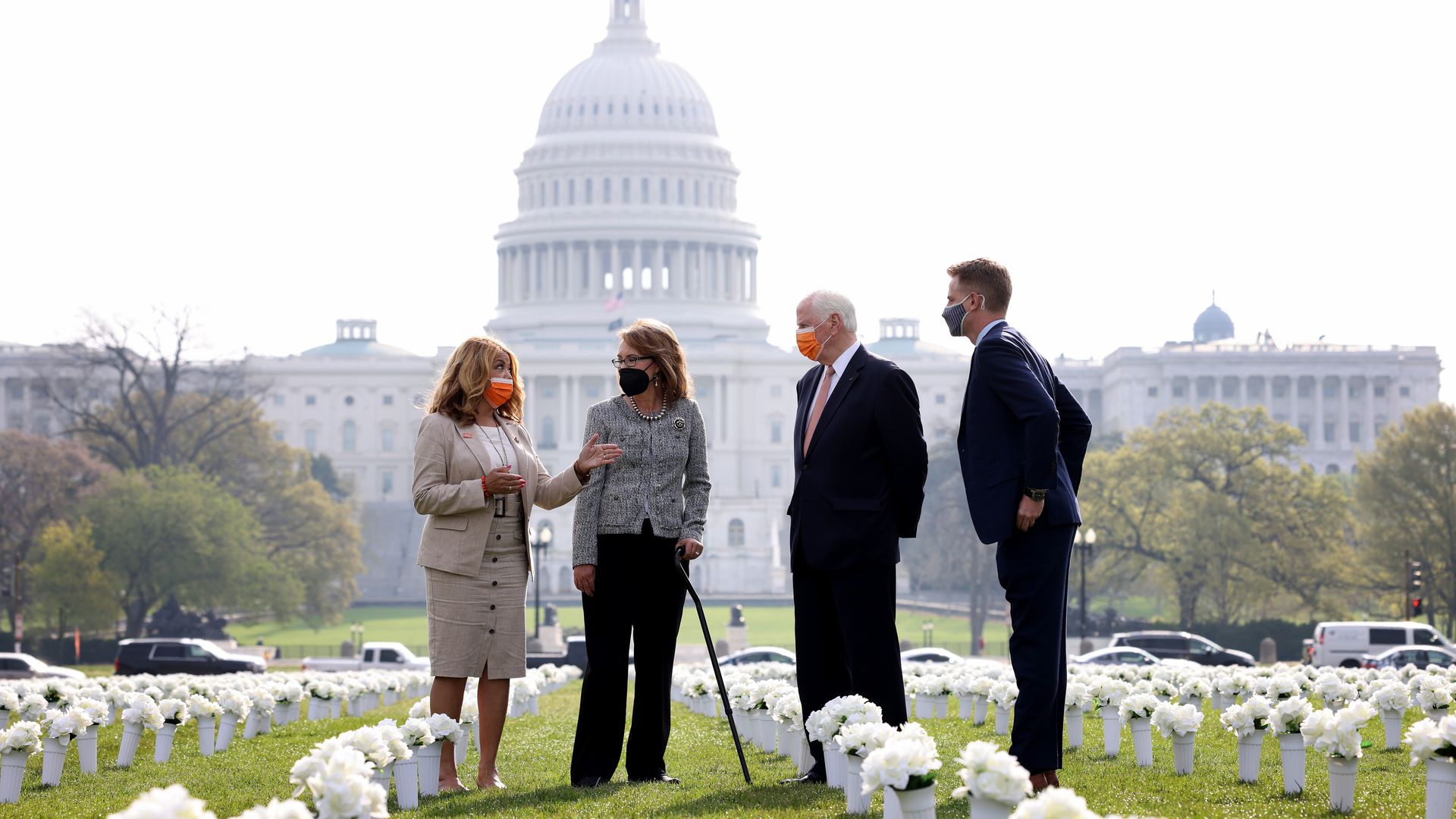 Former Rep. Gabby Giffords is seen amid a memorial to shooting victims erected on the National Mall.