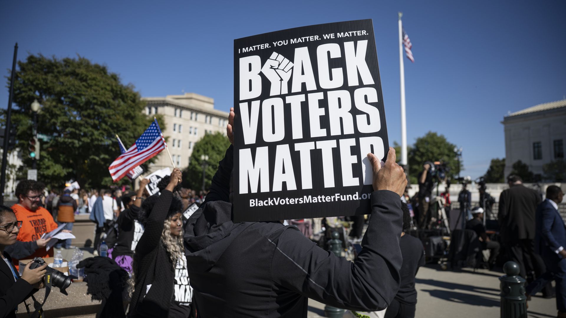 Demonstrators hold a "Black Voters Matter" sign outside the Supreme Court.
