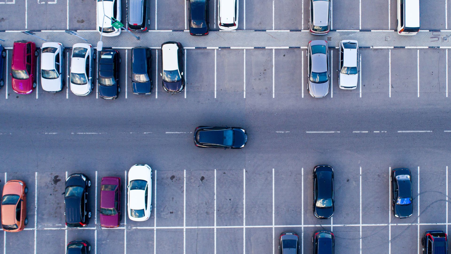 An overhead picture of cars in a parking lot.