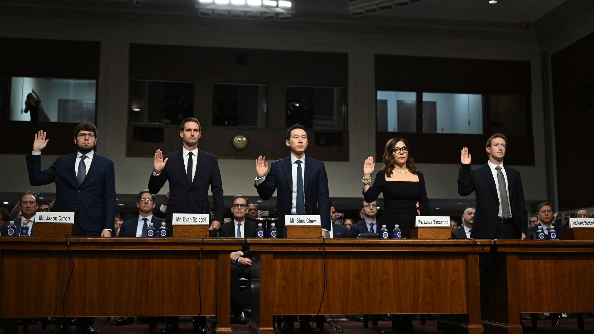 Jason Citron, CEO of Discord; Evan Spiegel, CEO of Snap; Shou Zi Chew, CEO of TikTok; Linda Yaccarino, CEO of X; and Mark Zuckerberg, CEO of Meta, are sworn in during the US Senate Judiciary Committee hearing on January 31, 2024.