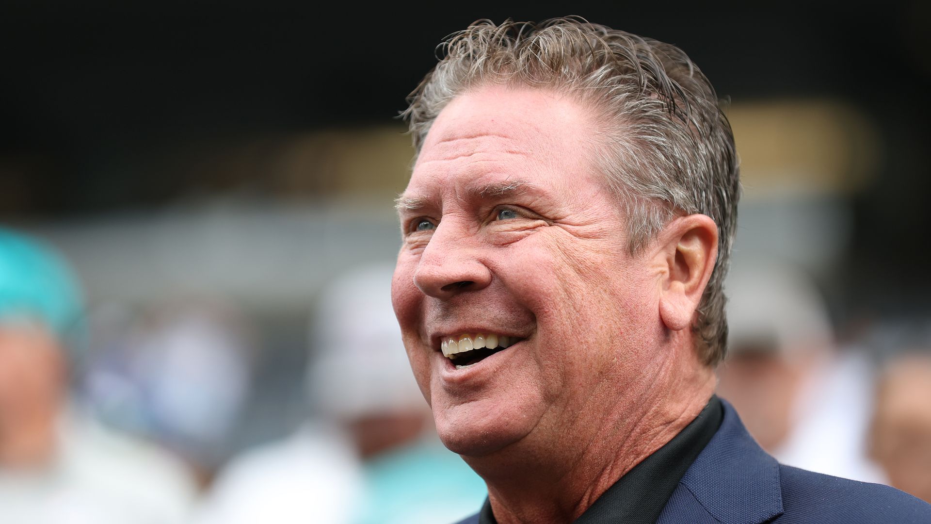 Dolphins legend Dan Marino smiling at an NFL game.