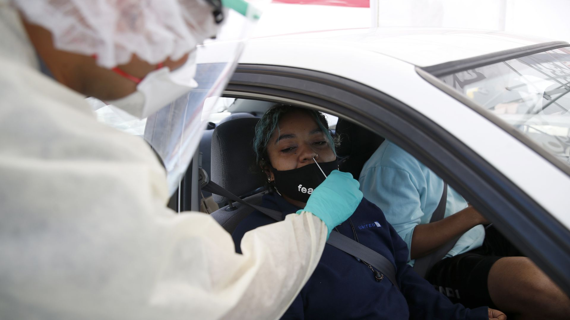 Person getting a COVID test in their car