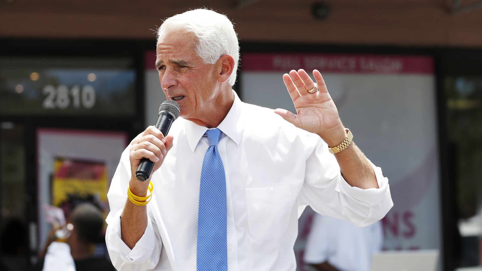 Rep. Charlie Christ wears a white dress shirt and a blue tie 
