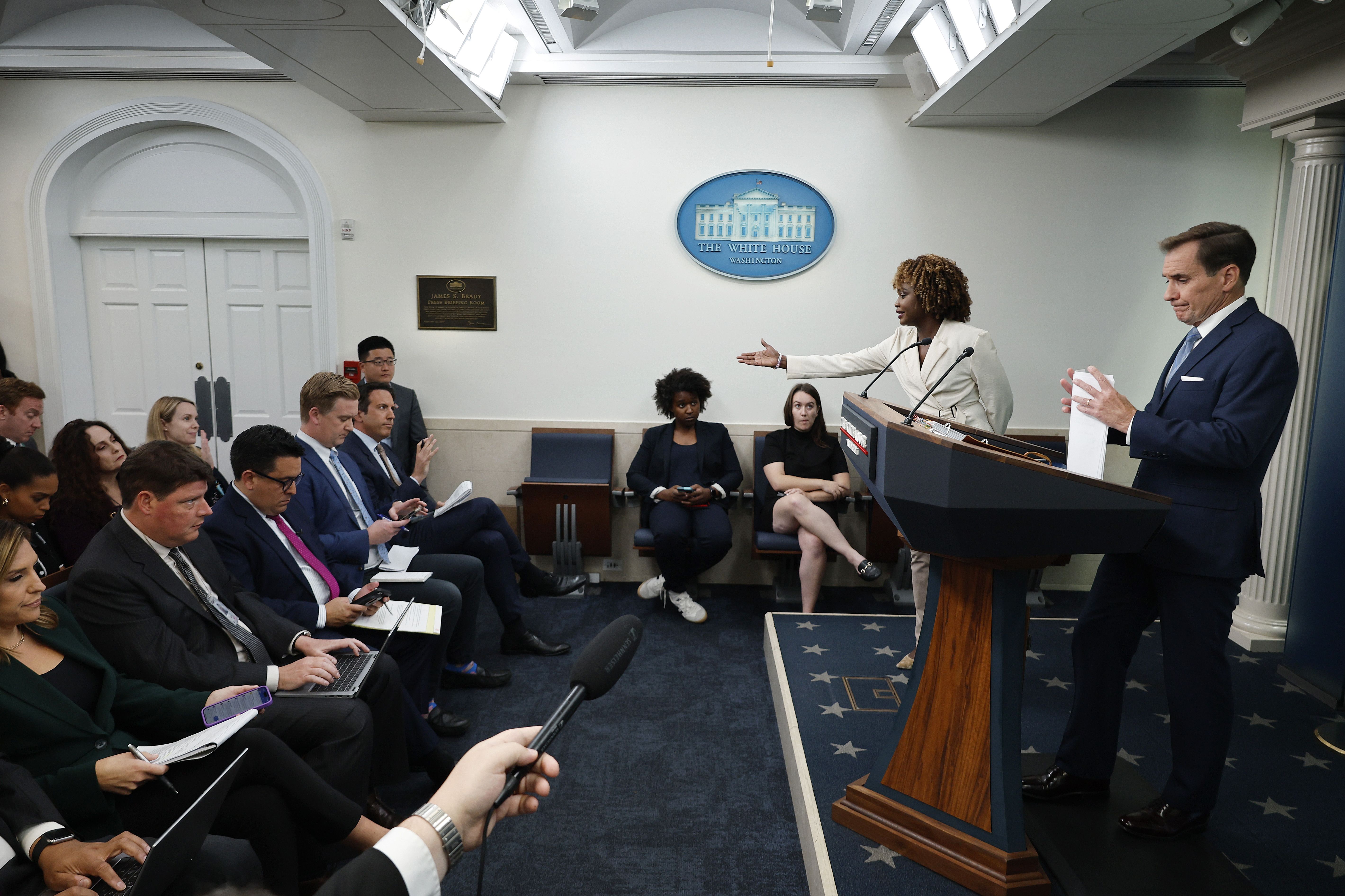 : White House National Security Communications Adviser John Kirby (R) and White House Press Secretary Karine Jean-Pierre talk to reporters in the Brady Press Briefing Room at the White House on September 18