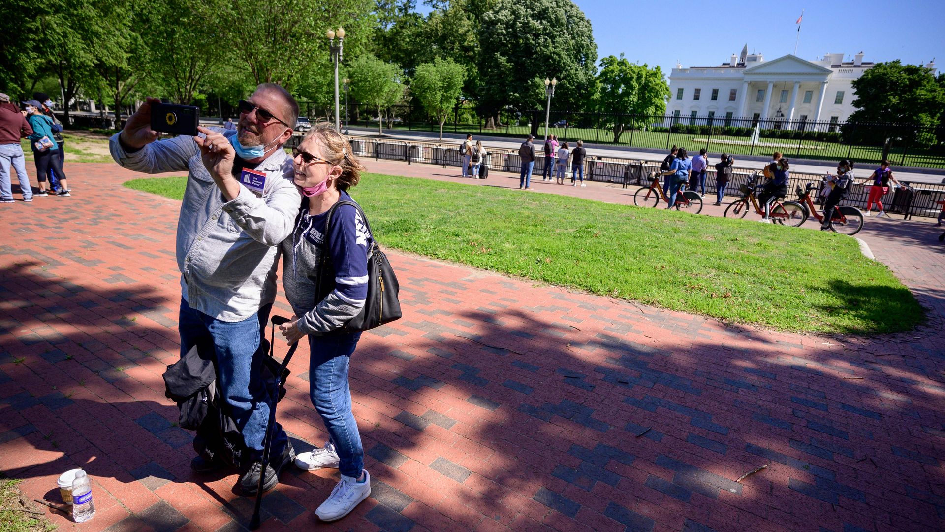 Tourists are seen snapping a selfie in front of the White House after Lafayette Park re-opened to the public.