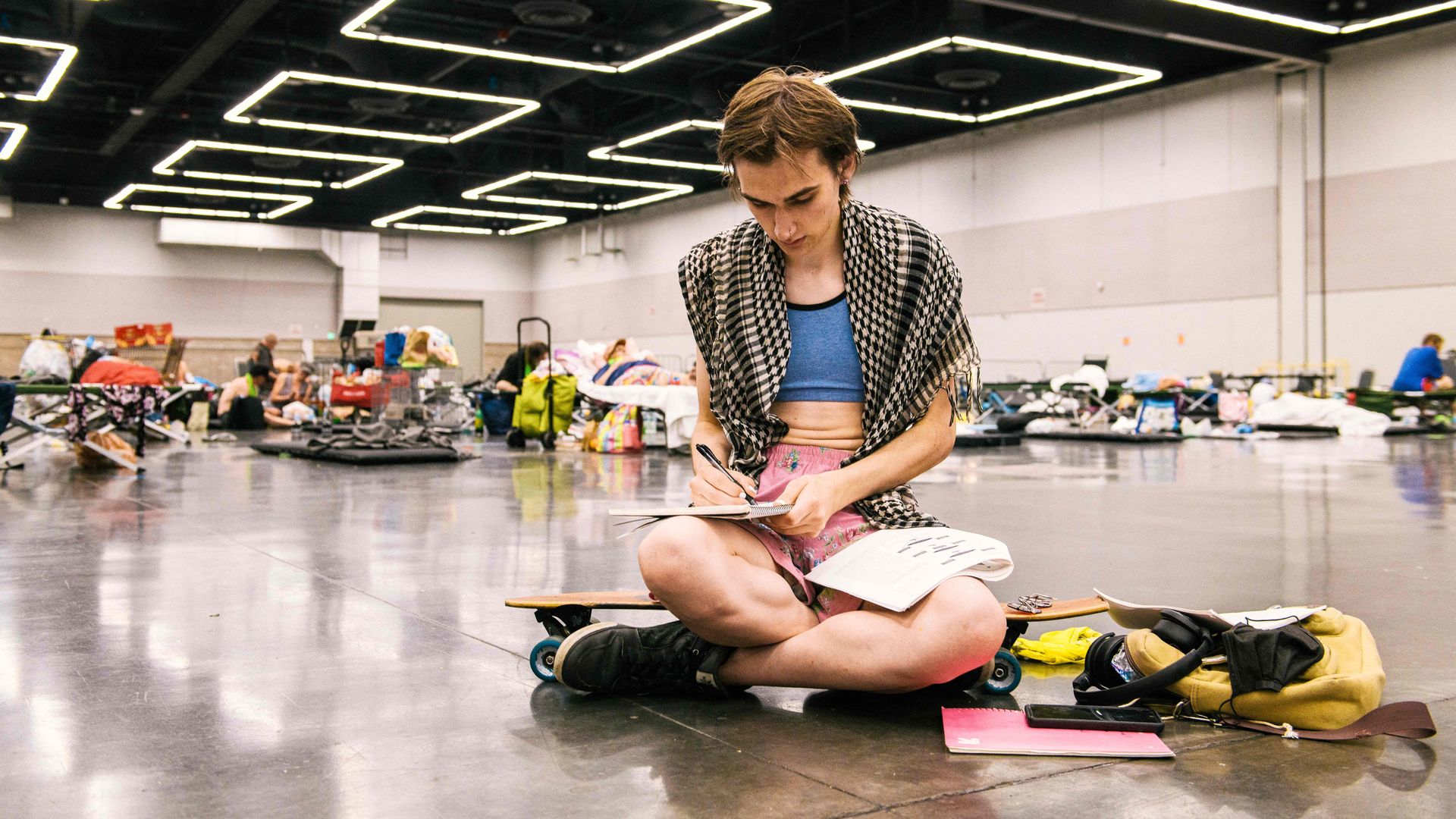 Woman writing in a cooling center in Portland, Oregon during a deadly heat wave in 2021.