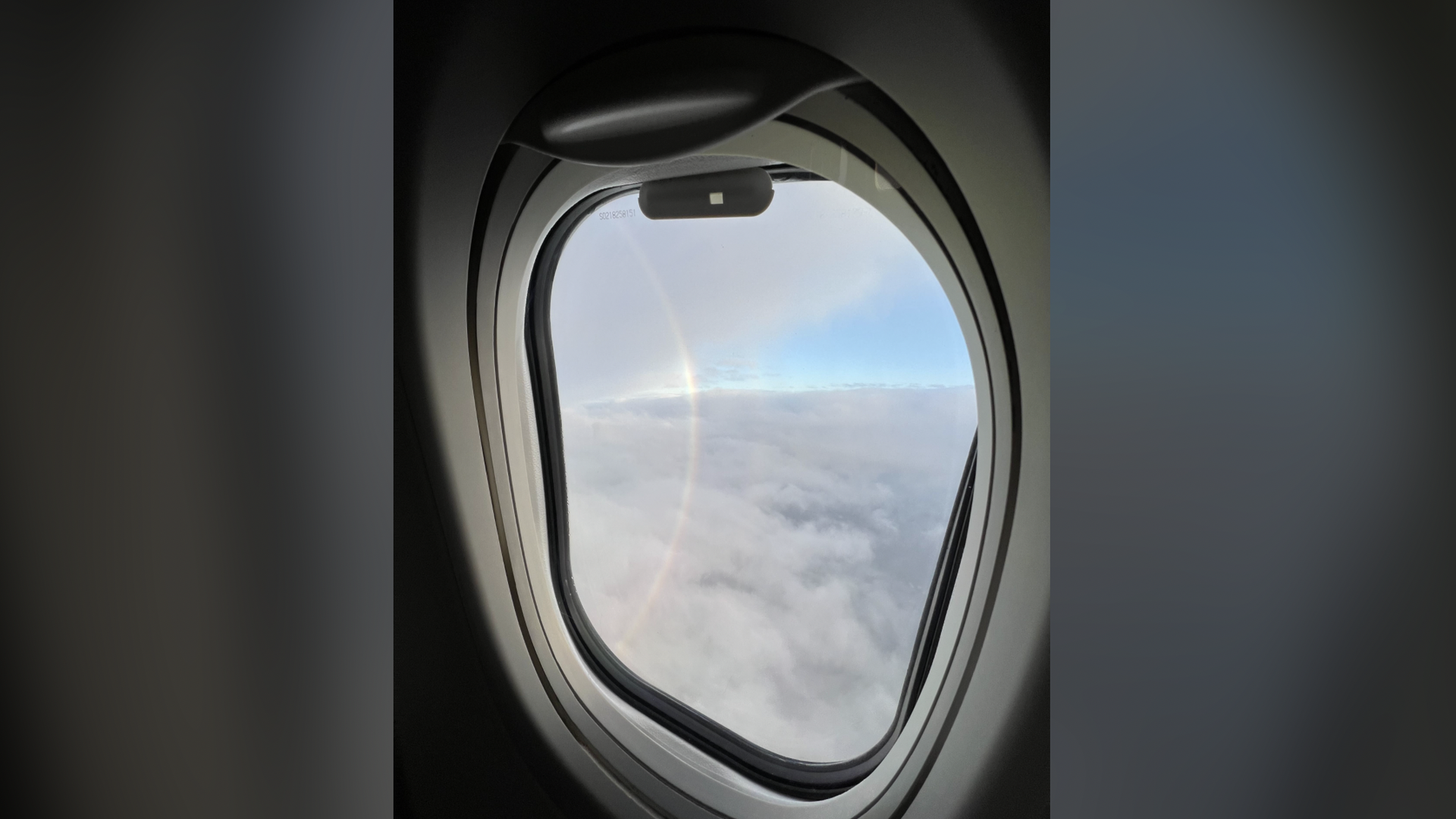 A vertical rainbow seen from an airplane
